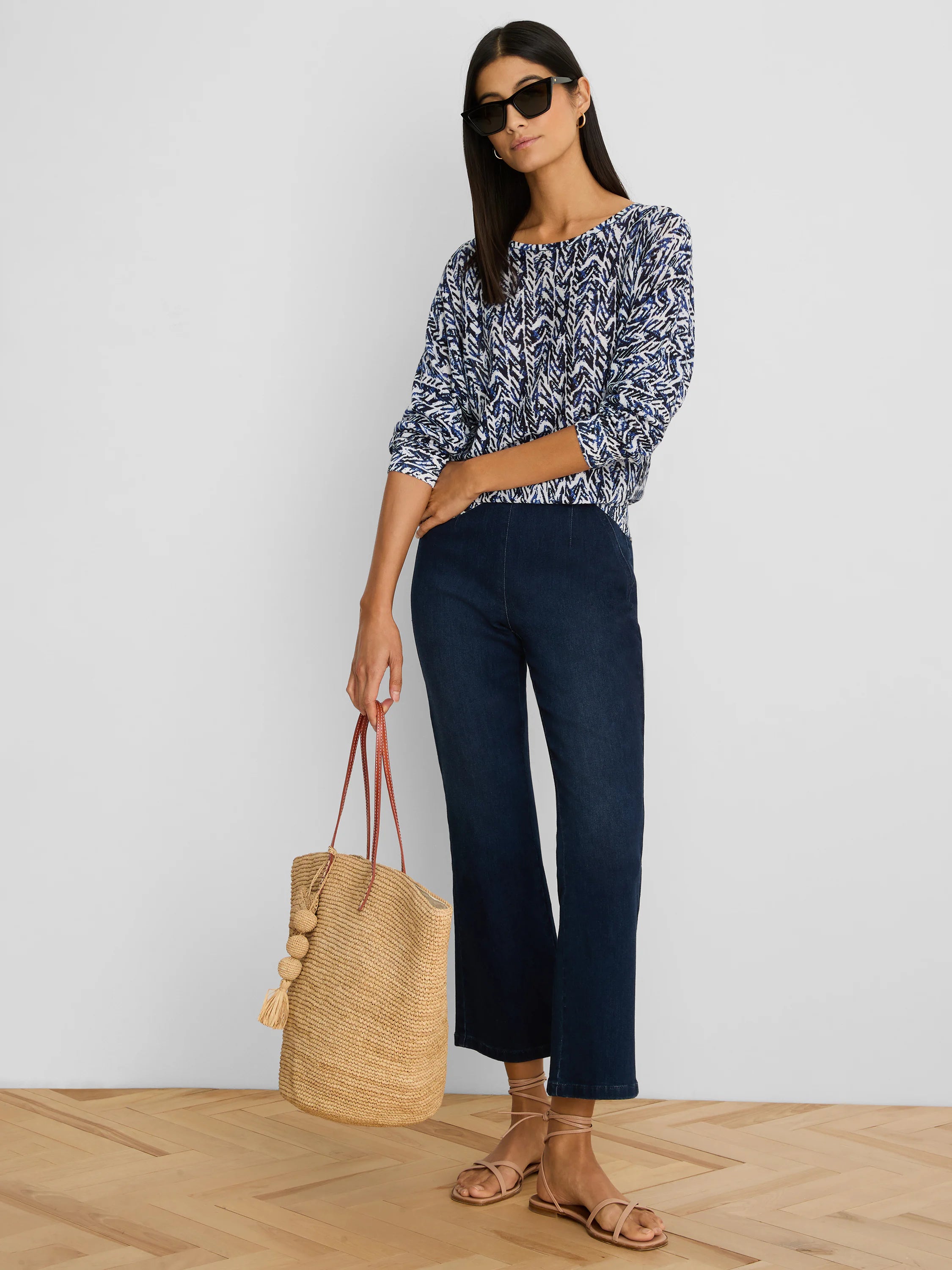 White sweater with indigo crosshatch pattern, relaxed fit, wide neckline, 3/4 sleeves.