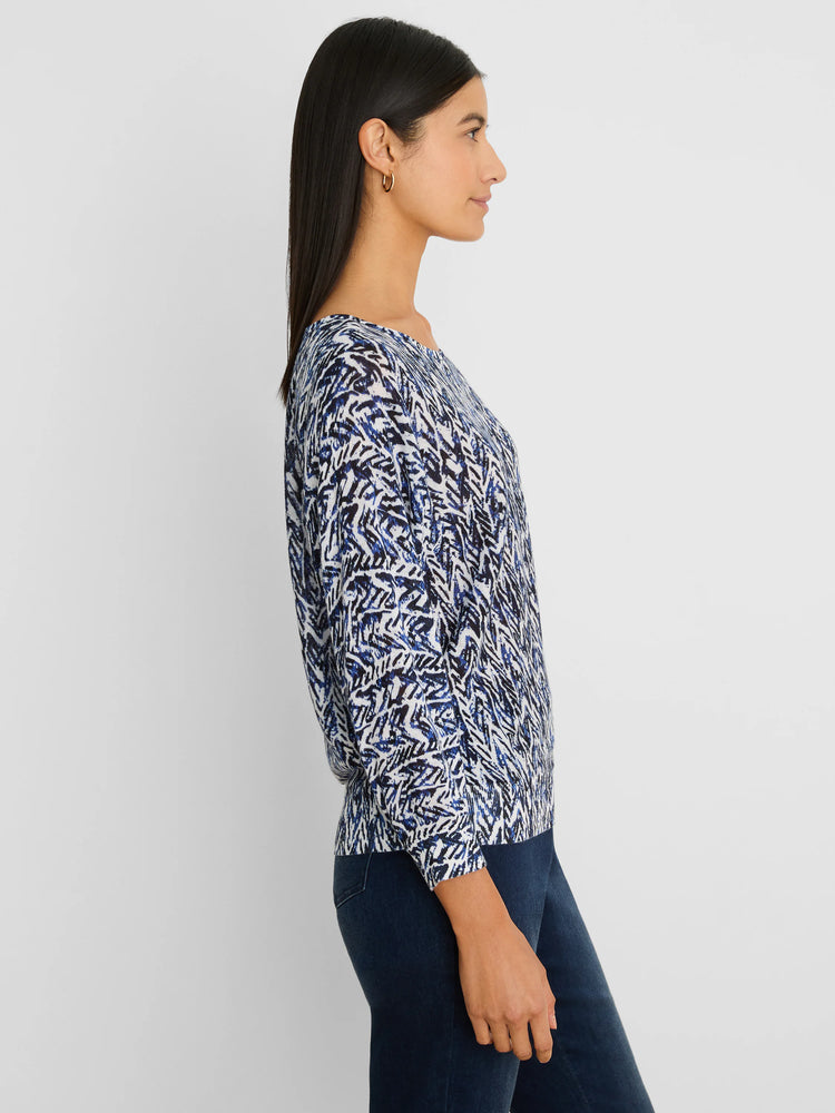 Loose-fit sweater with an abstract indigo, light blue, and white crosshatch pattern. Features a wide neckline.