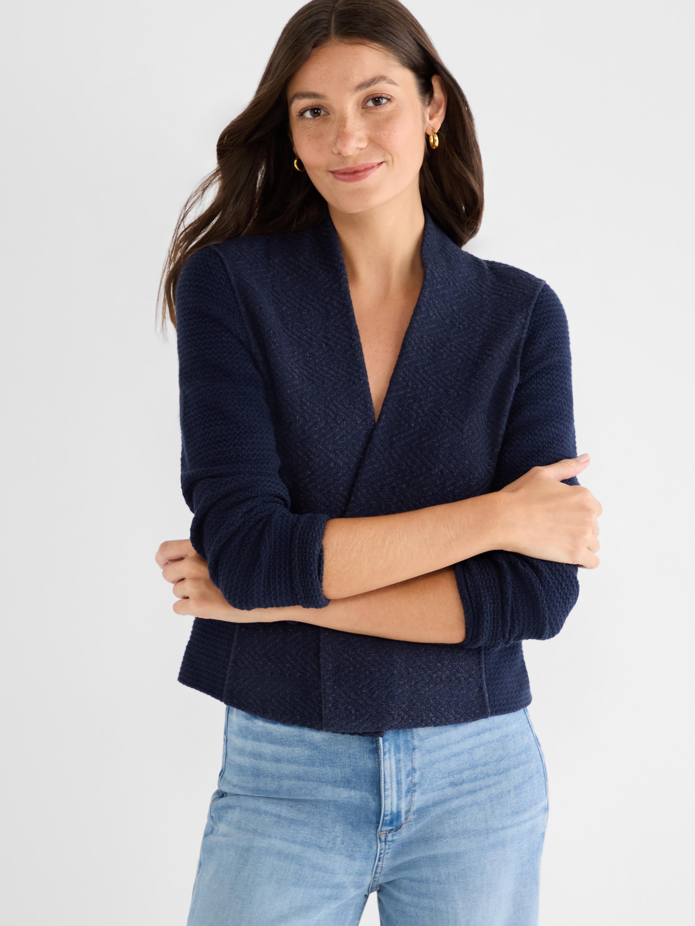 Cropped navy textured knit jacket with a structured fit and wide shawl lapels.