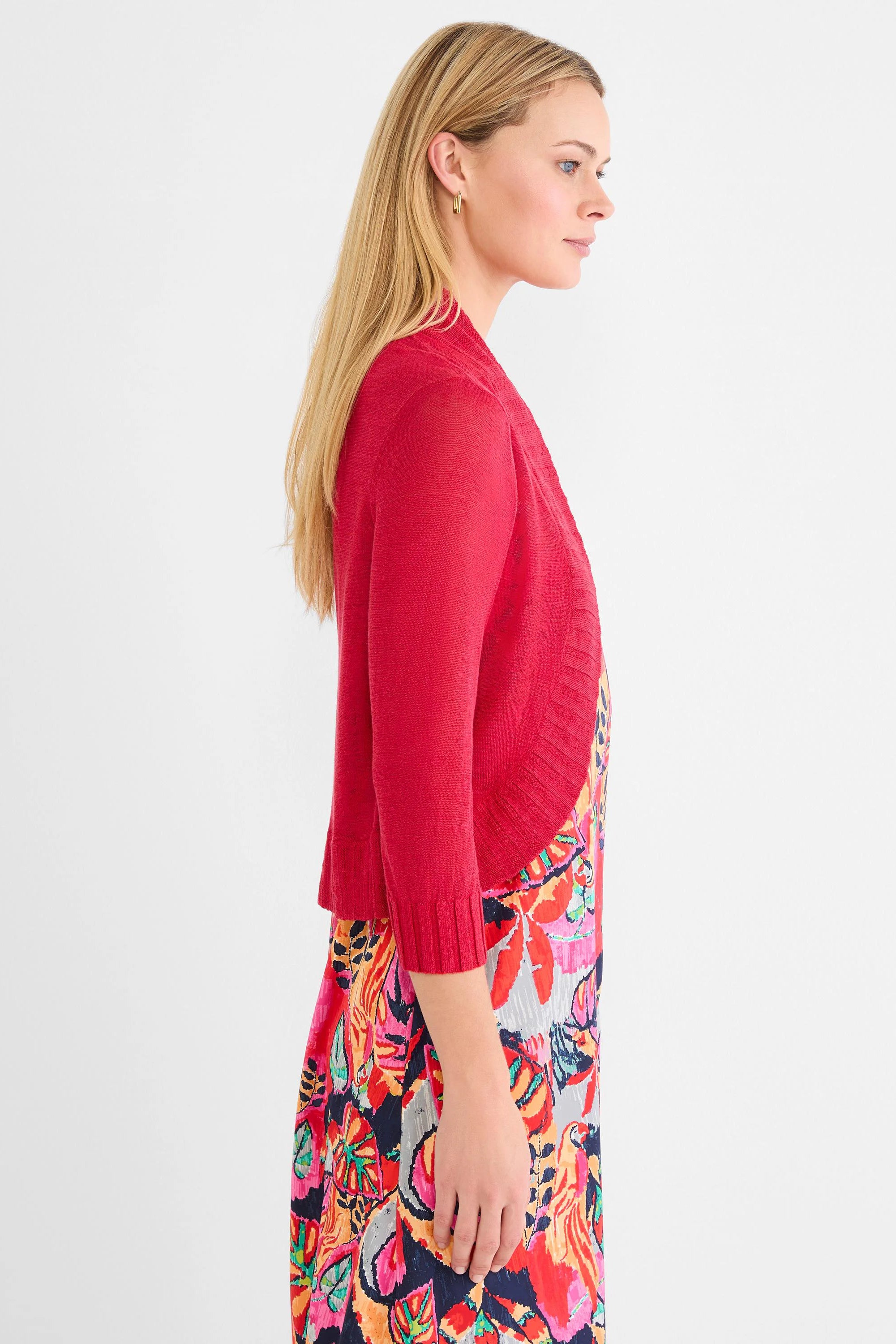 Red bolero cardigan. Cropped, open front, with 3/4 sleeves and ribbed cuffs/trim.