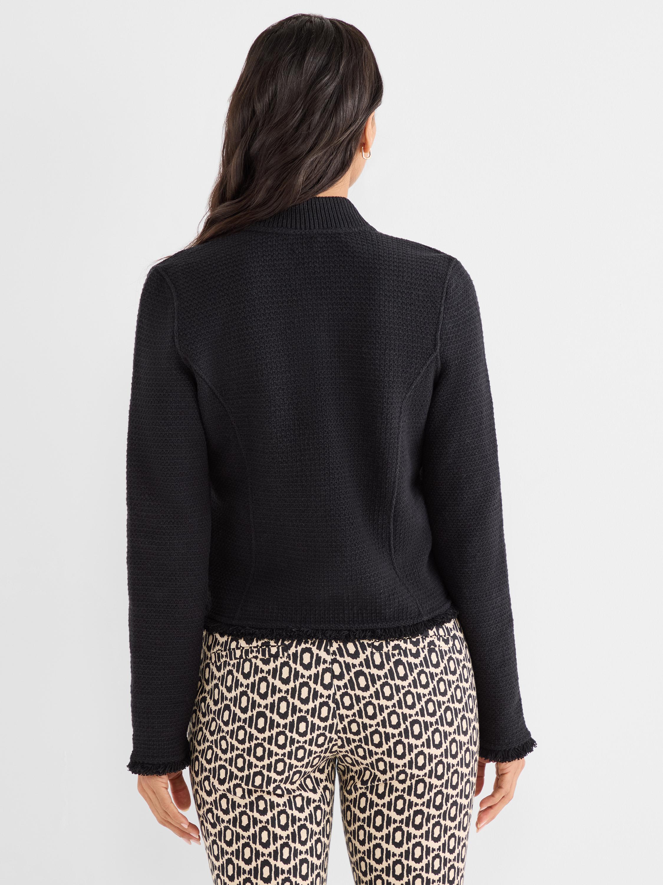 Model wears a fitted black textured knit jacket with a mock neck and subtle frayed hem and cuffs.