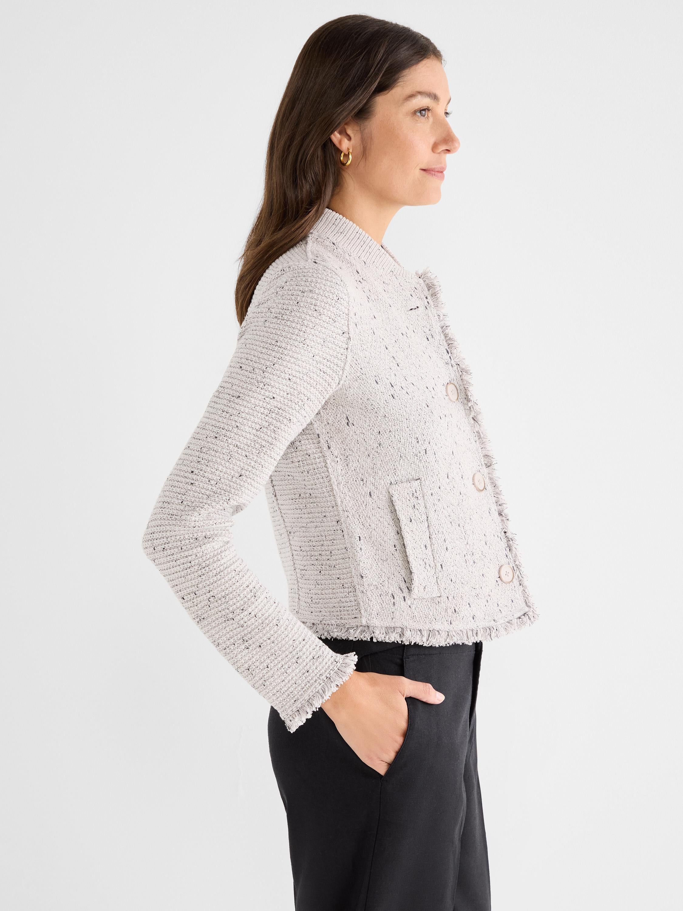 Light gray speckled tweed jacket featuring a cropped, fitted silhouette, collarless design, and raw fringe trimming.