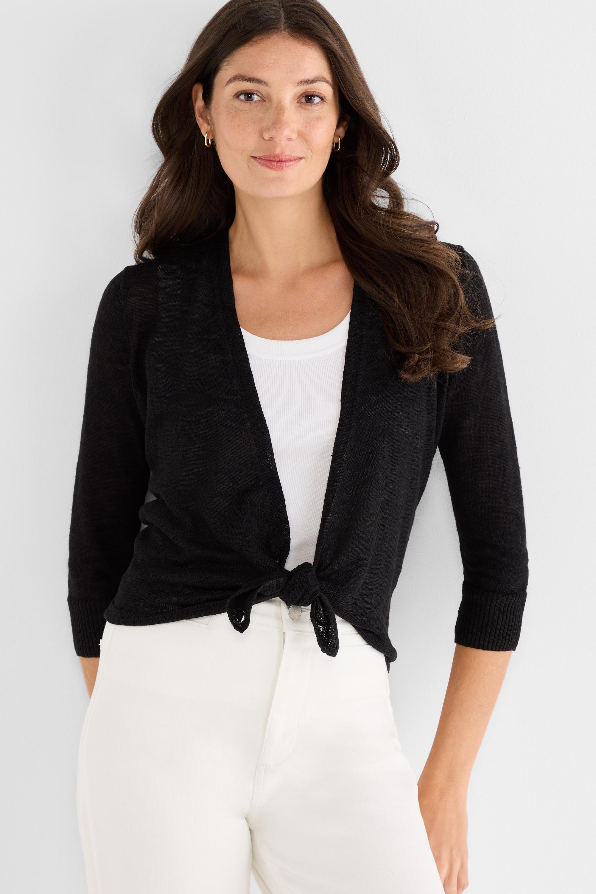 Black lightweight cardigan worn cropped featuring a front tie knot closure and elbow-length sleeves.