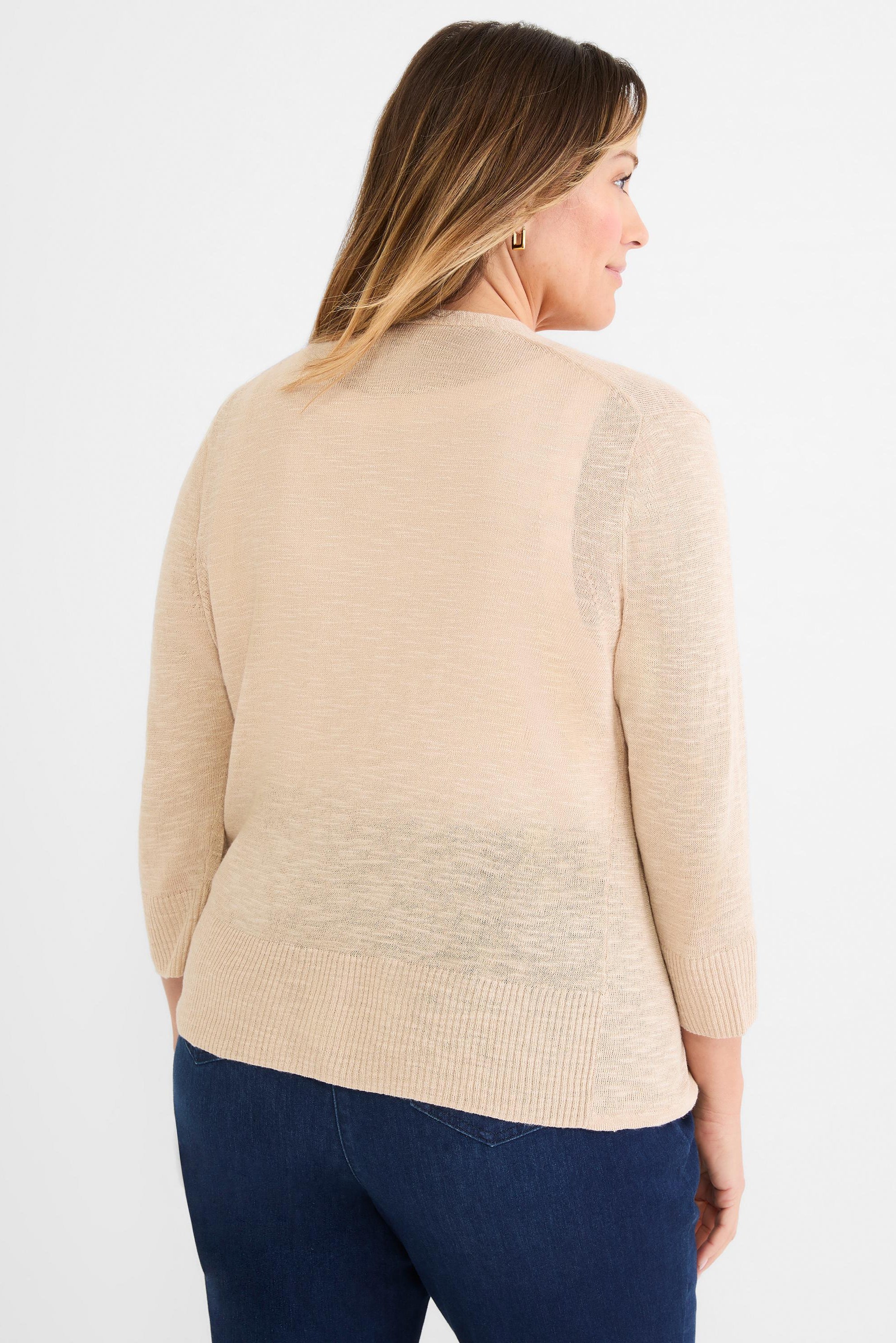 Beige fine-knit open cardigan featuring sheer texture, three-quarter sleeves, and a ribbed hip-length trim.