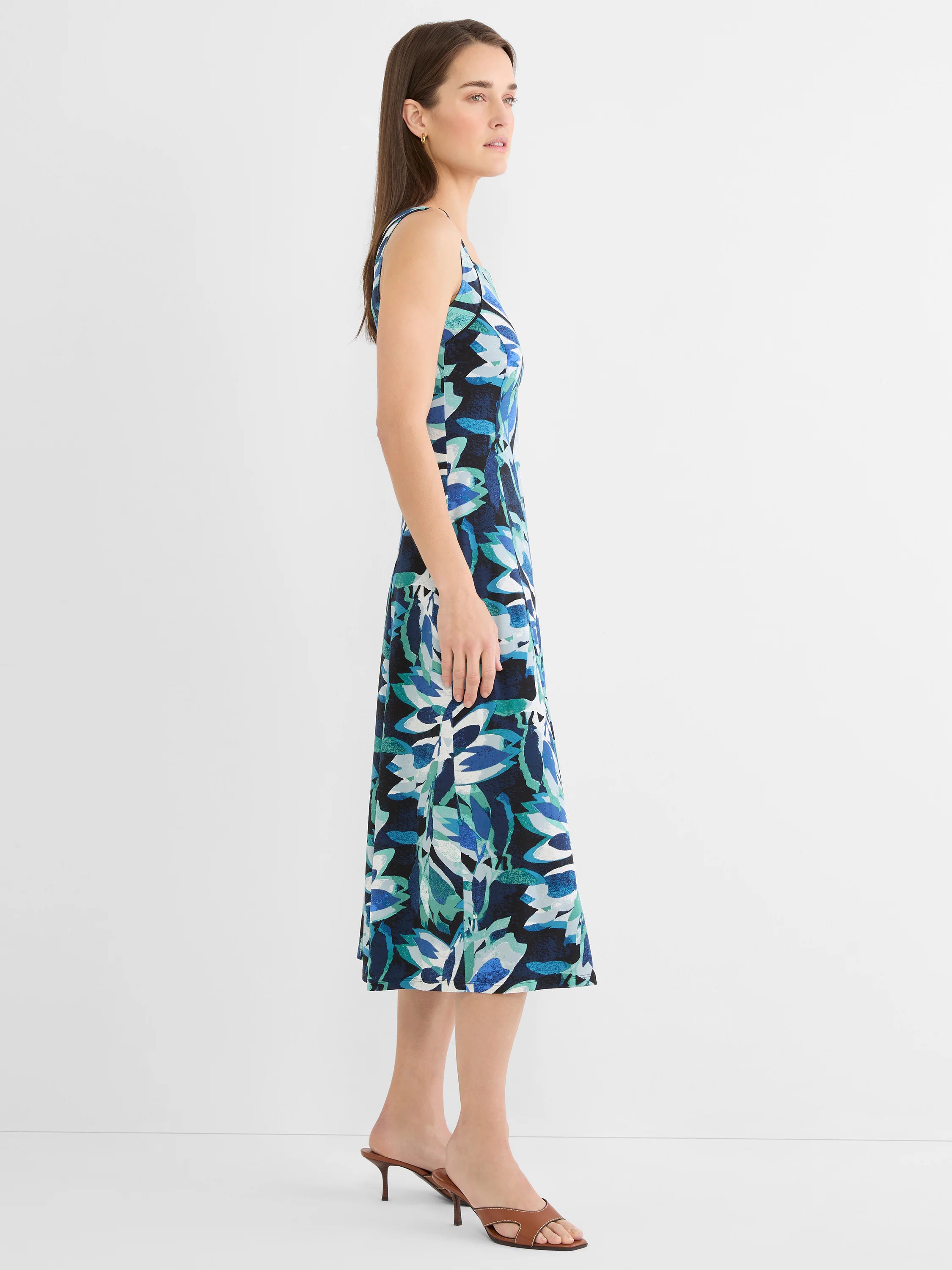 Sleeveless knit midi dress with a blue, teal, and white abstract leaf pattern on a dark ground.
