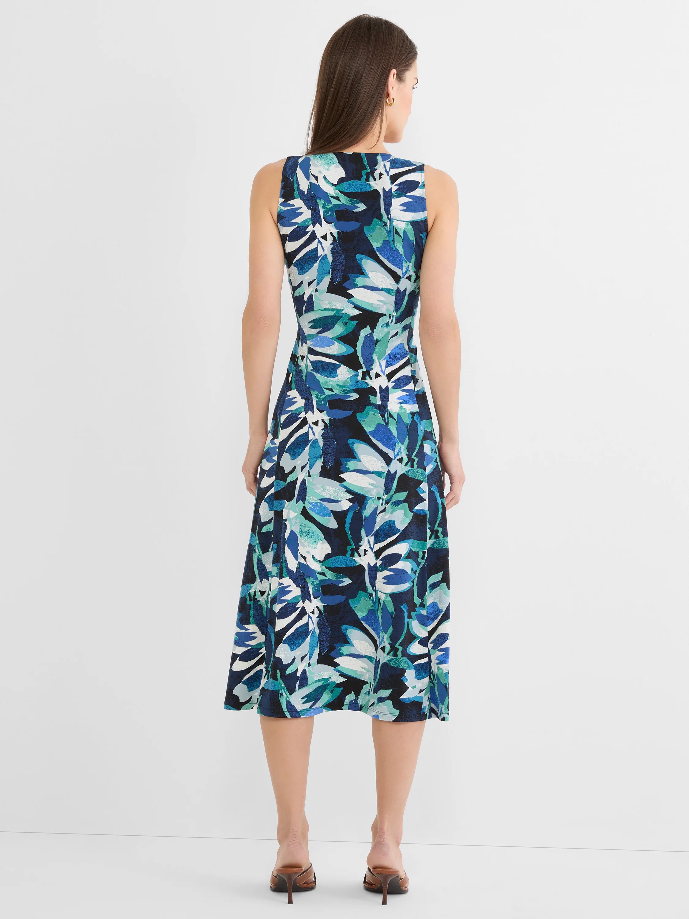 Sleeveless knit A-line dress with abstract leaf print in shades of blue, teal, white, and black. Midi length, seen from back.