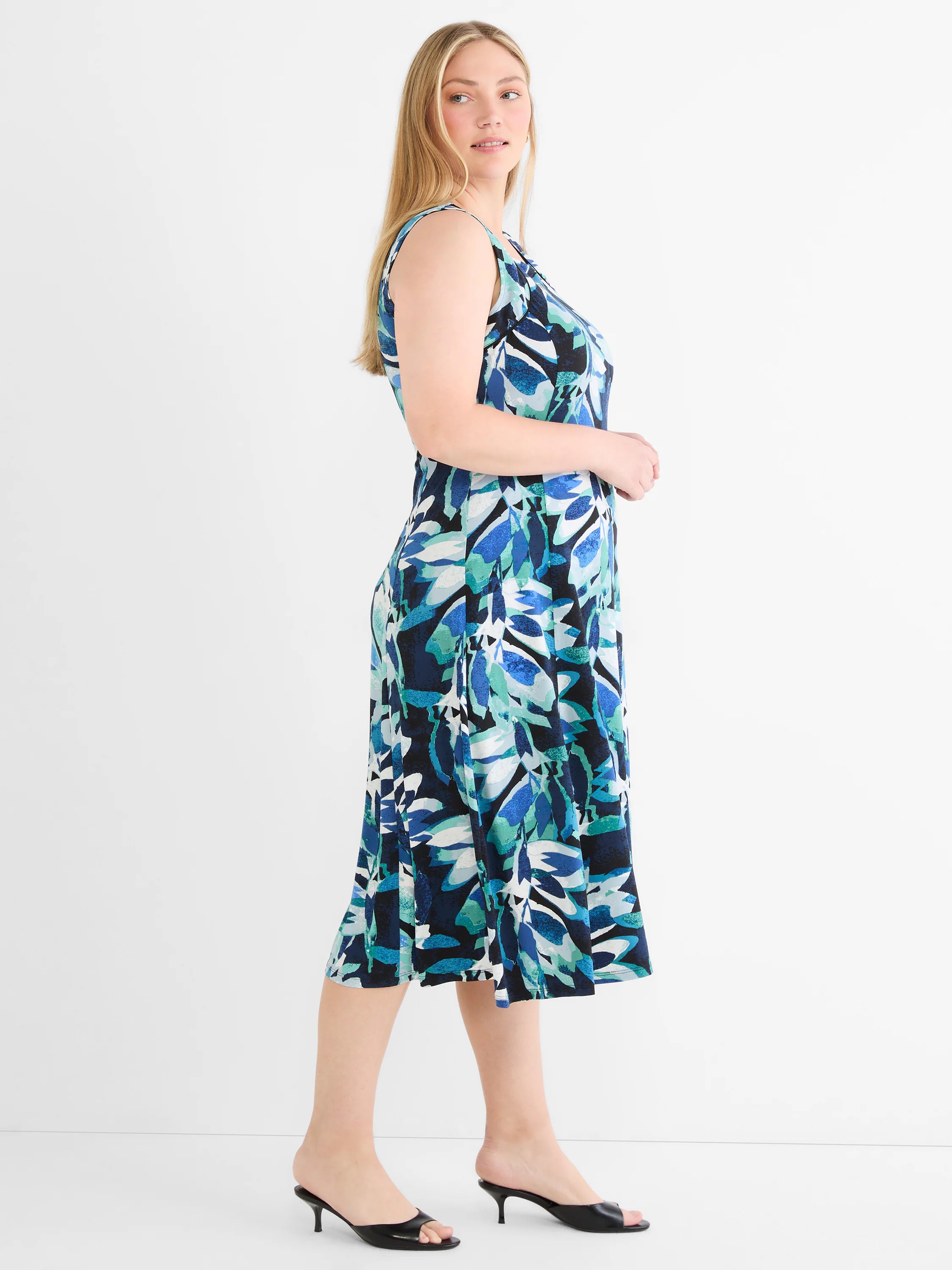 Sleeveless midi knit dress with abstract leaf pattern in shades of blue, teal, black, and white.