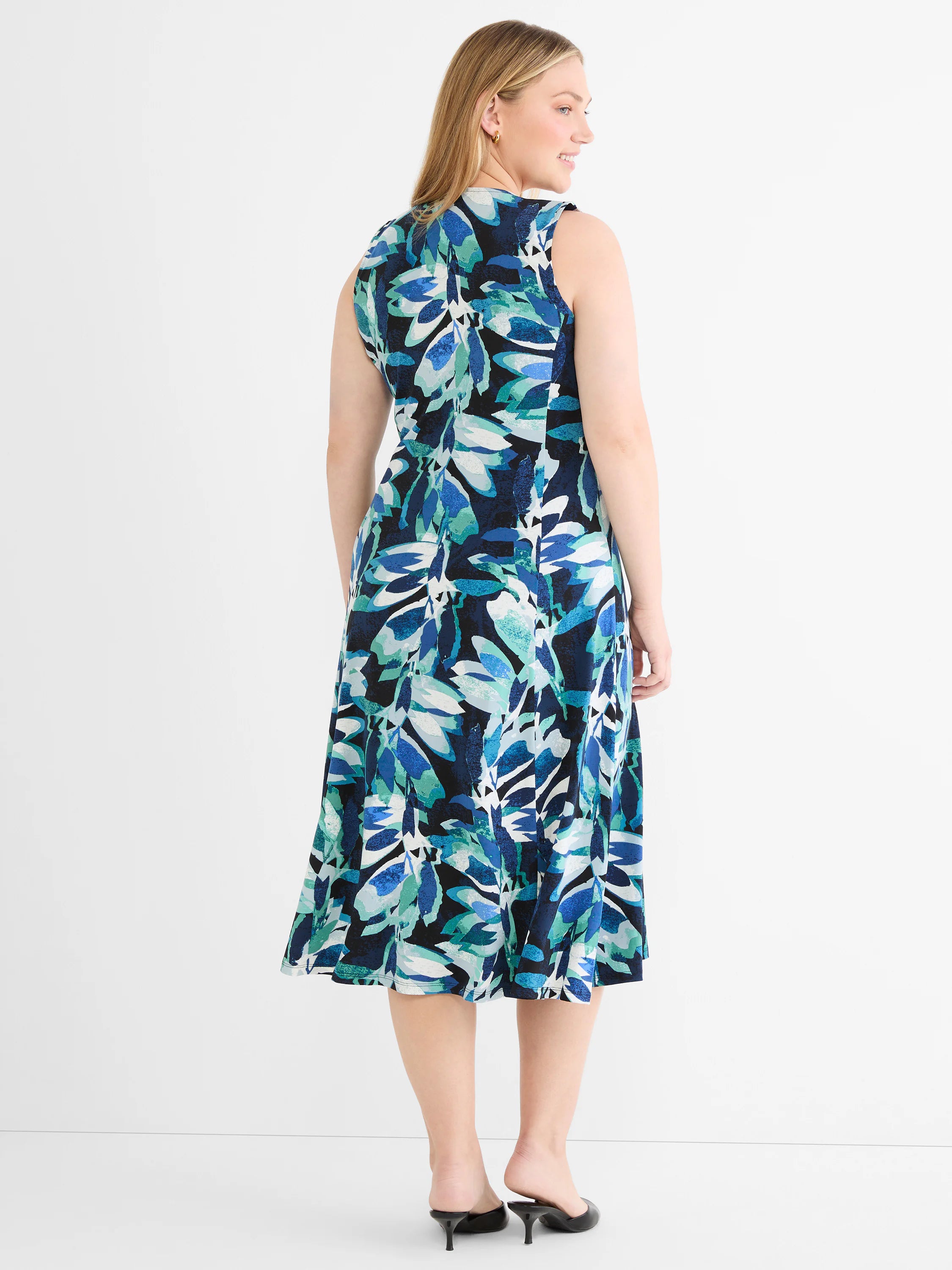 Sleeveless midi dress with an abstract leaf pattern in blues, teal, black, and white.