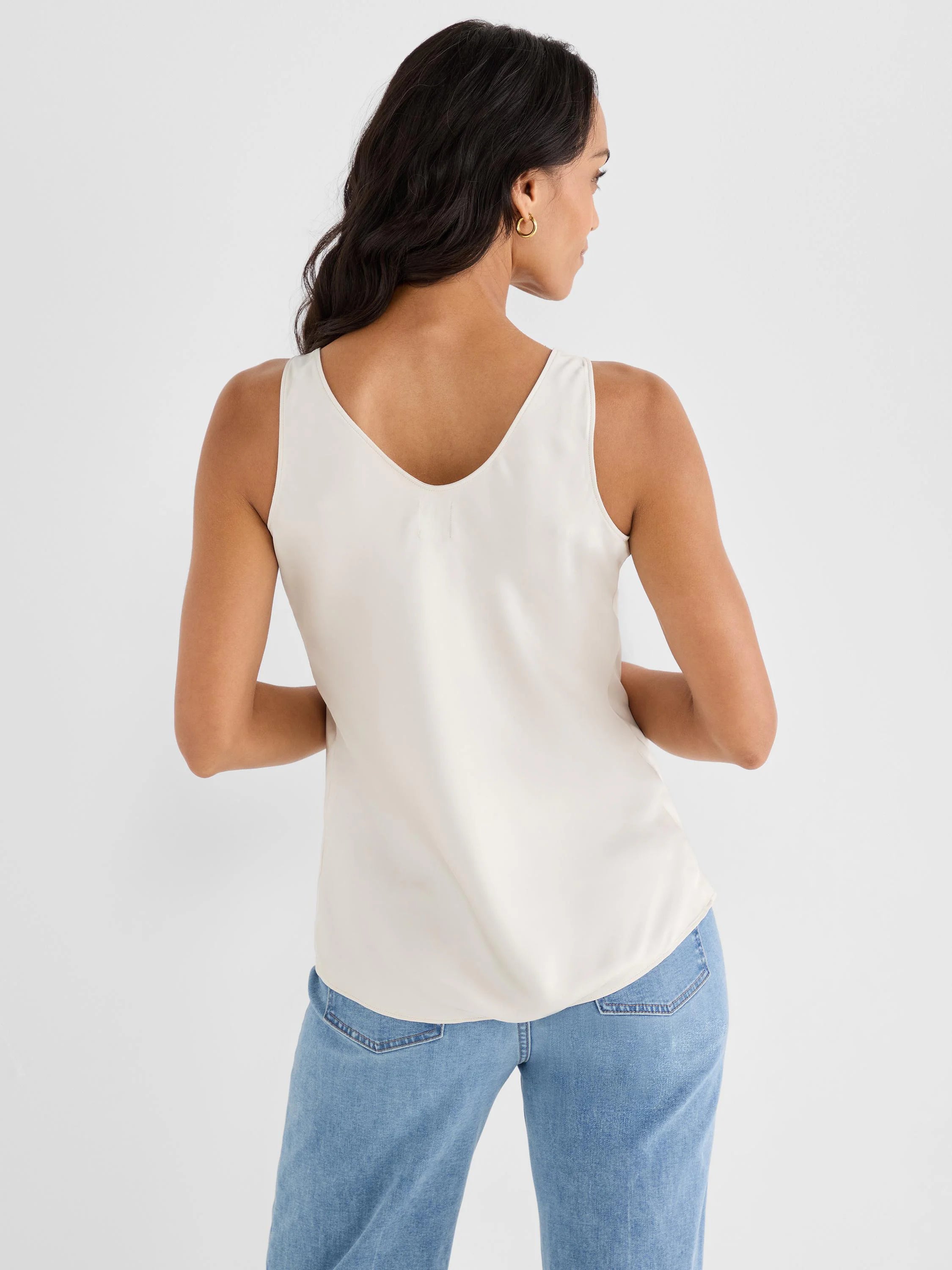 Off-white glossy woven tank. Sleeveless with a V-neck back.