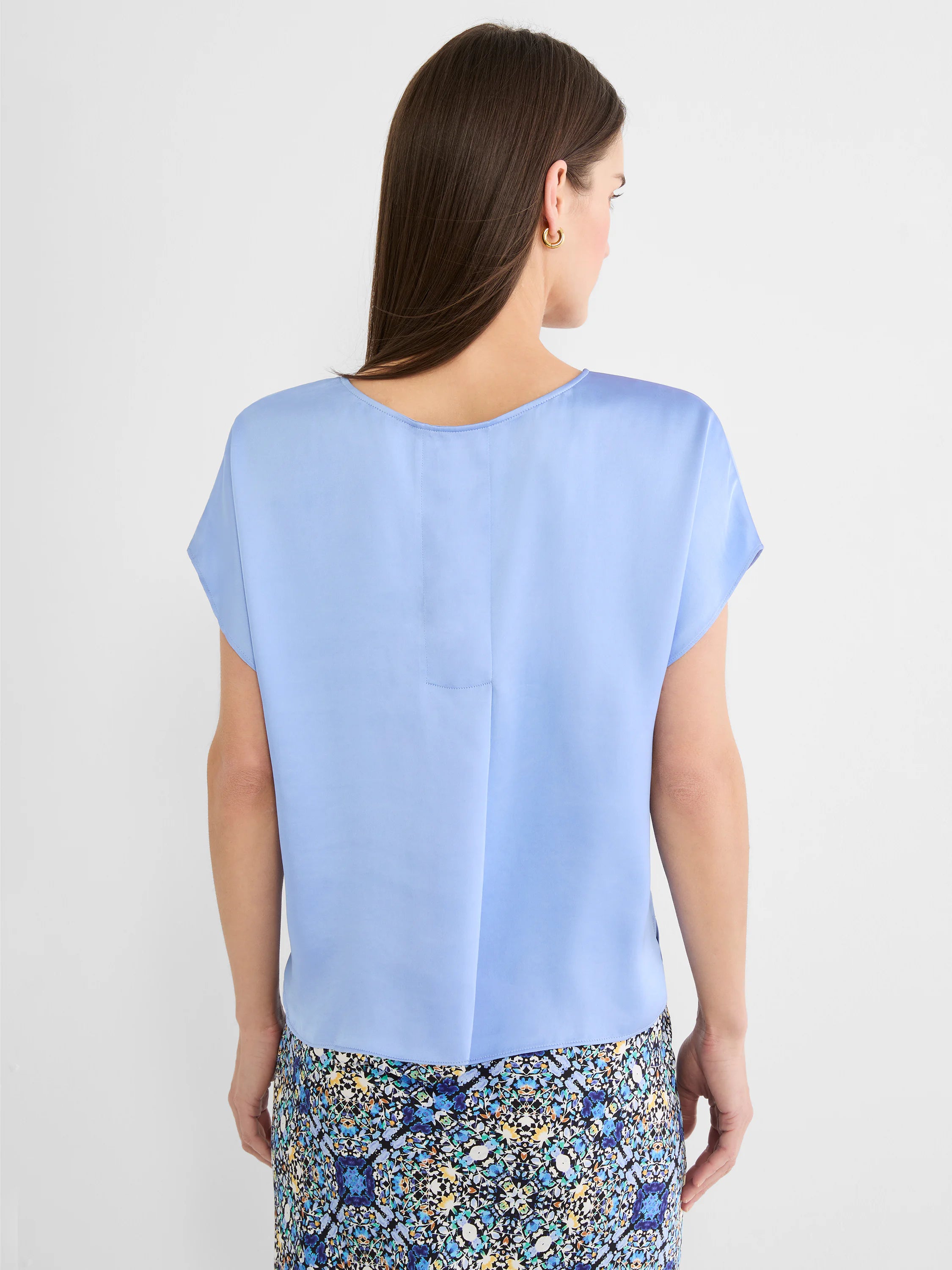 Light blue woven tee with a subtle sheen, relaxed fit, scoop neck, and short cap sleeves, shown from the back.