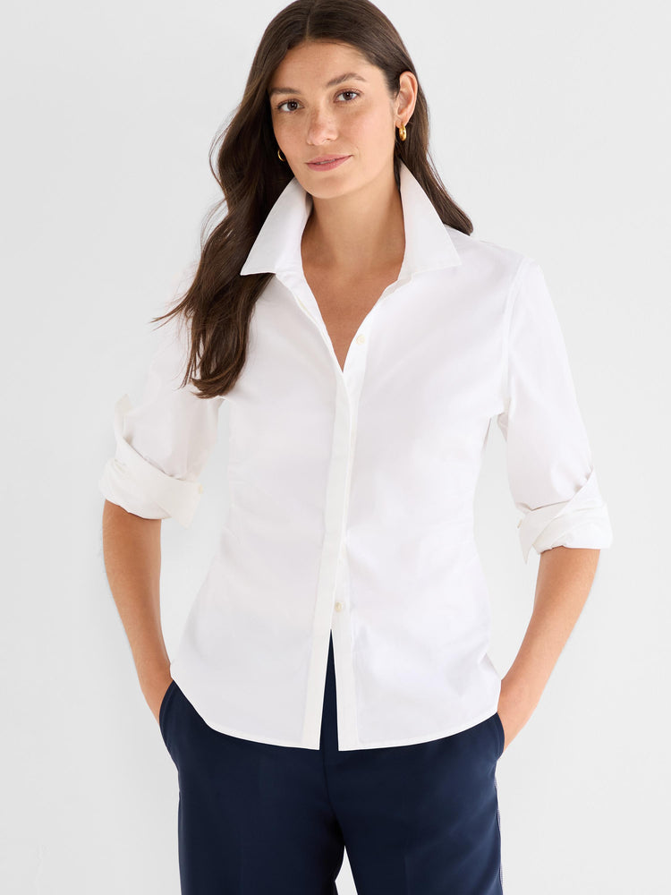 White fitted button-down shirt with a wide collar and sleeves rolled to the elbow.