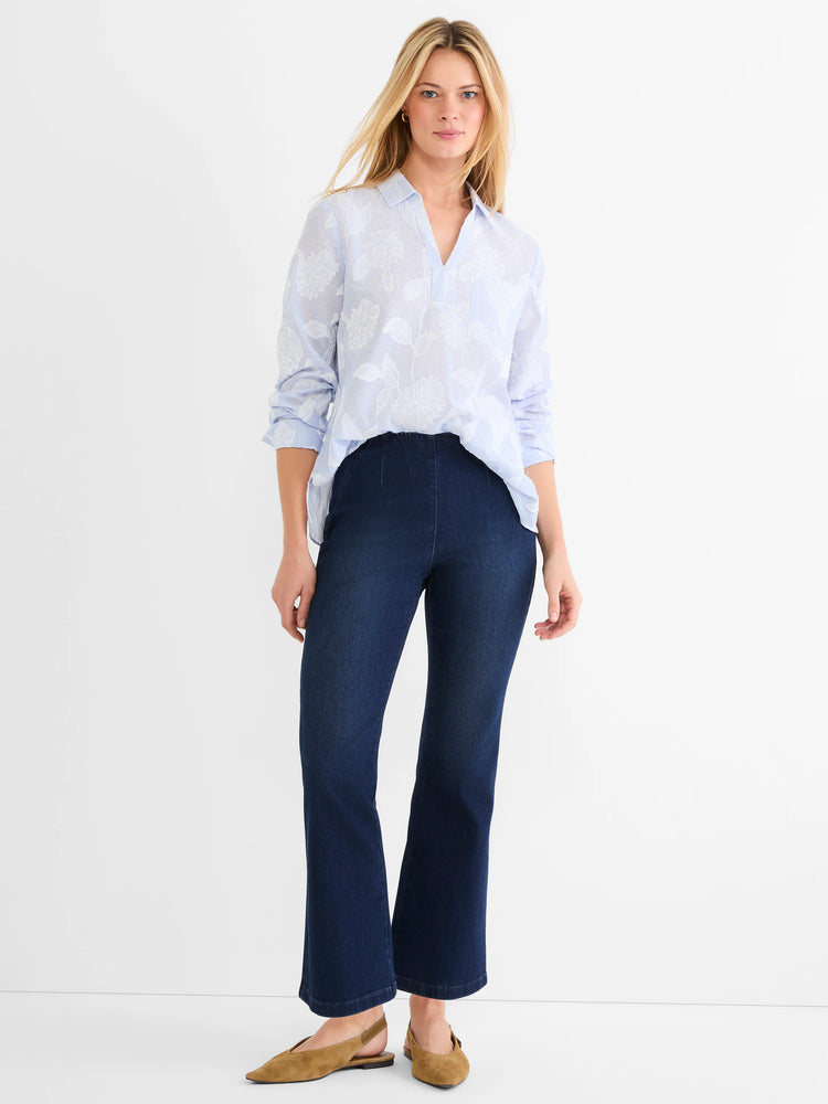 Sky blue V-neck top with white stripes and raised jacquard floral pattern. Collared, with a high-low hem.