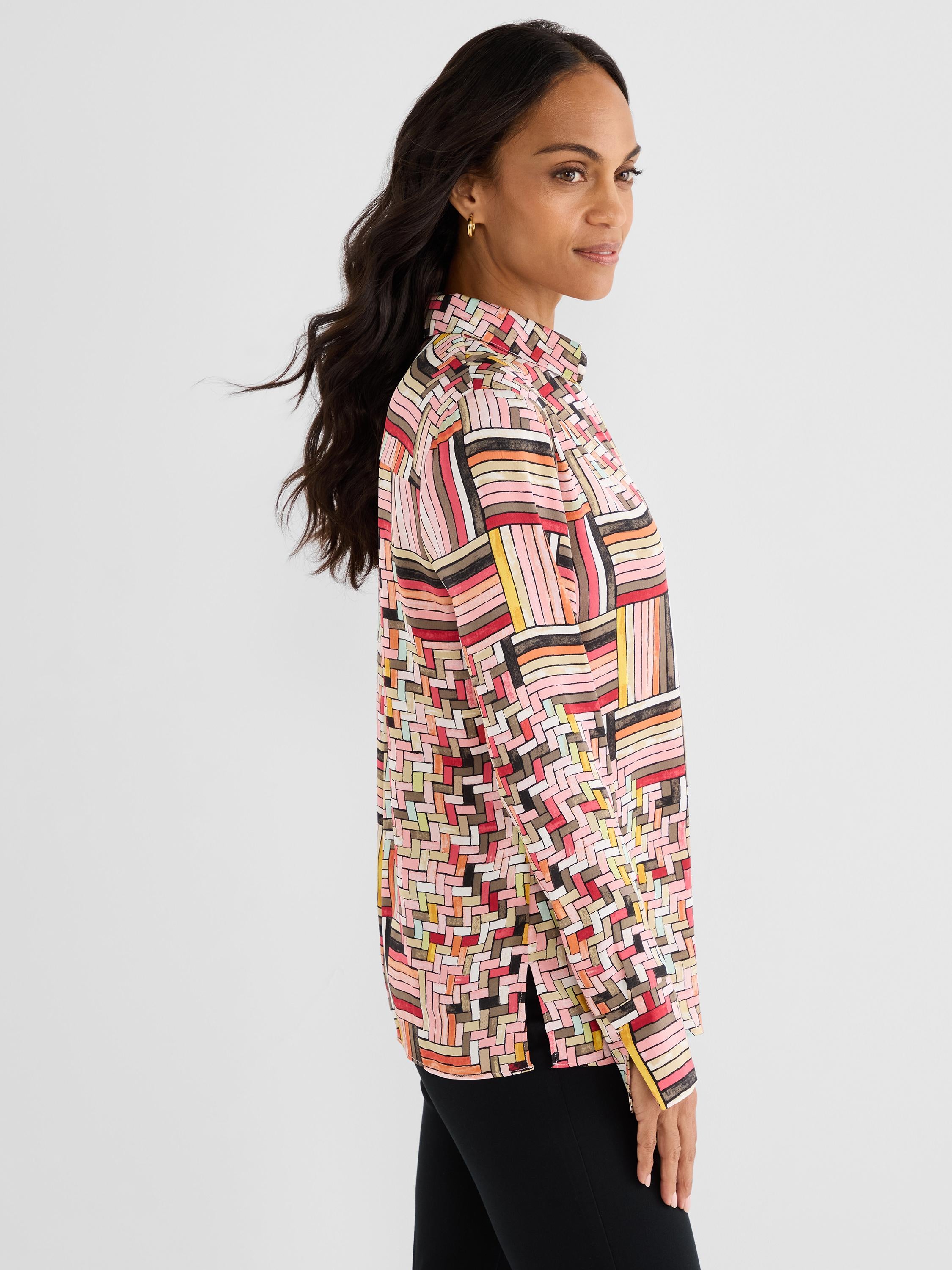 A relaxed fit multicolored long-sleeved blouse features a vibrant geometric print, a classic collar, and side slits.
