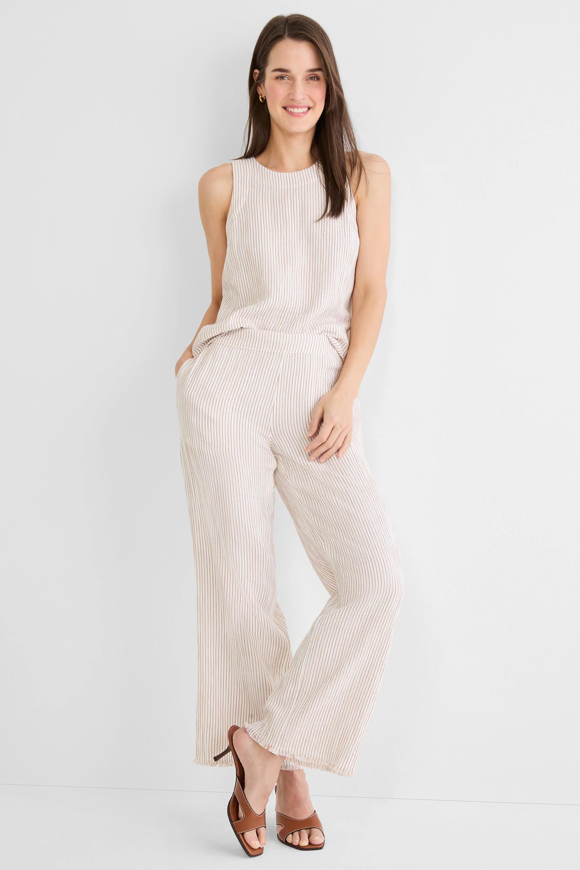 Light beige sleeveless tank with thin brown vertical stripes and a rounded neck.