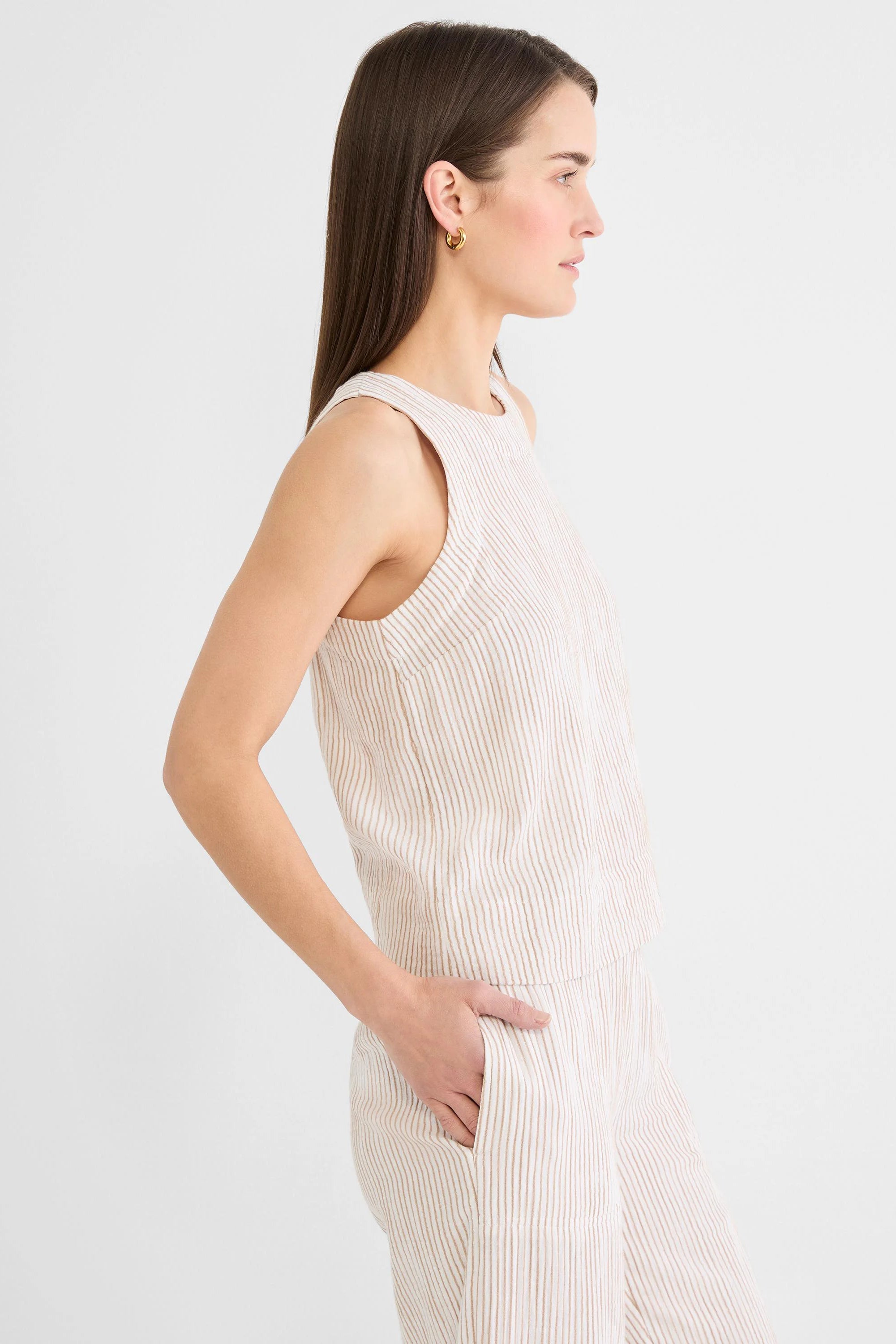Cream gauze tank with thin brown vertical pinstripes and a round neck.