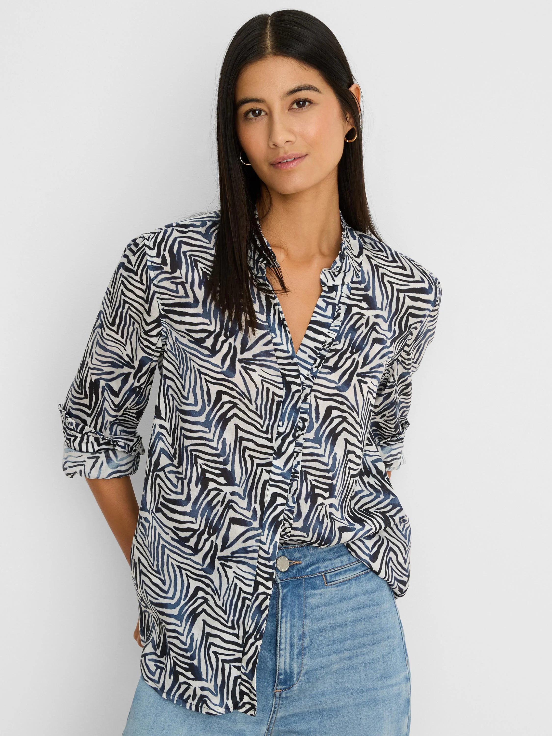 Off-white collared shirt with black and dark blue inked lines pattern, V-neck, and rolled sleeves.