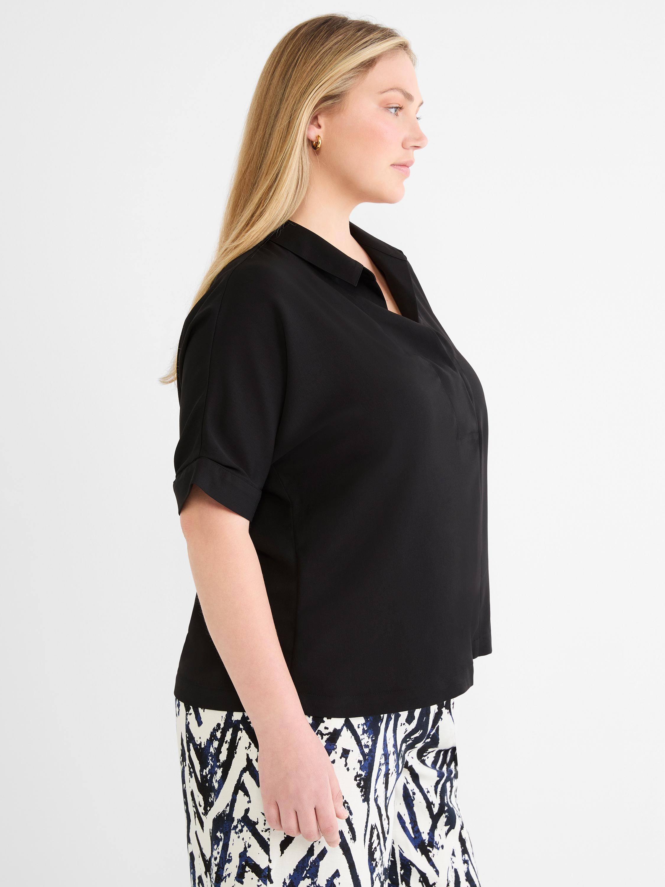 A relaxed black short-sleeve blouse featuring a revere collar and subtle cuffed sleeves.