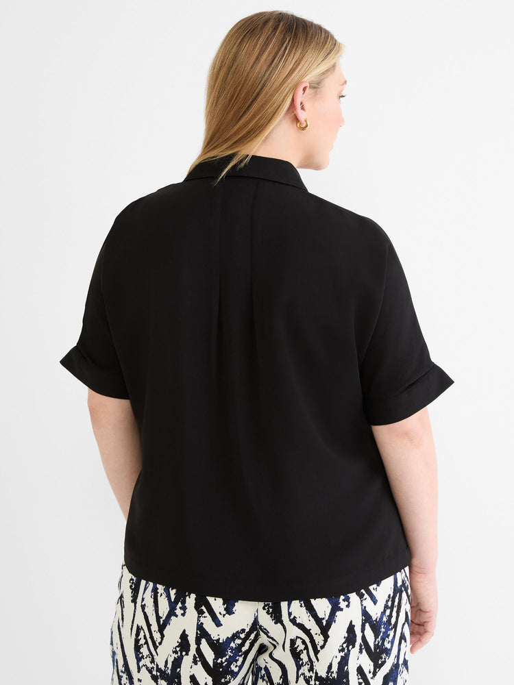 Flowy black collared blouse featuring short cuffed sleeves and a subtle back pleat detail.