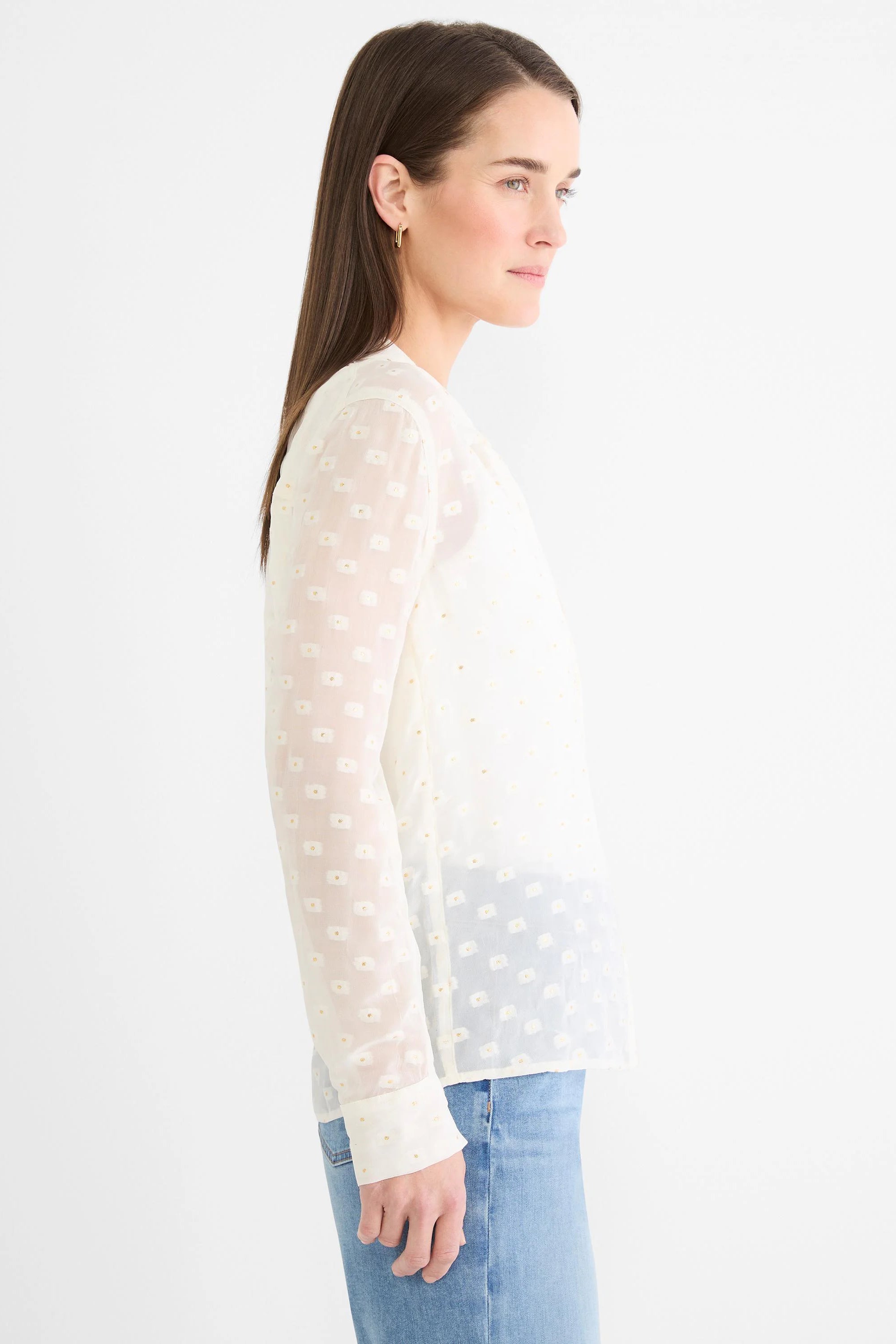 Off-white semi-sheer long-sleeve shirt with subtle gold dot pattern.