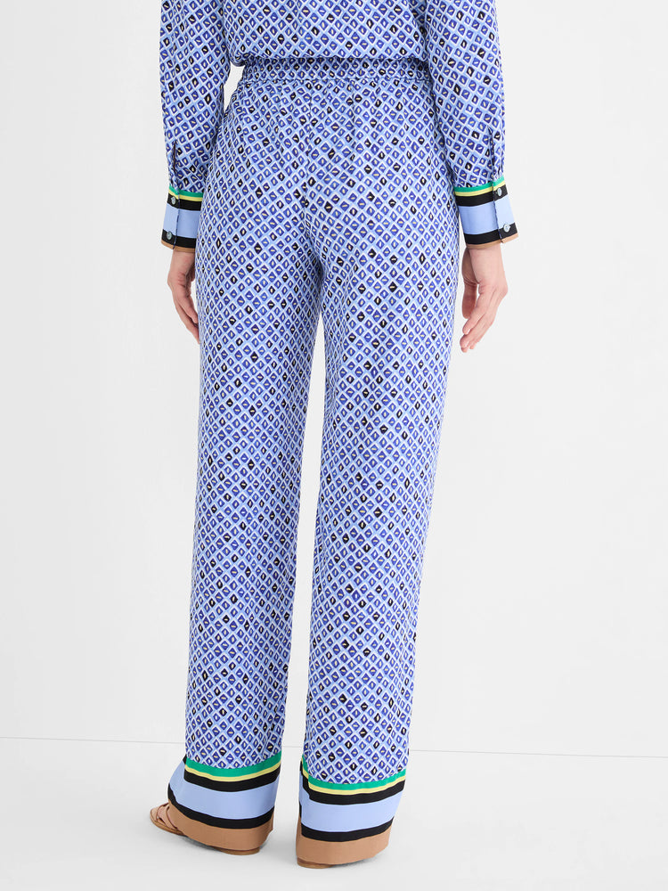 Blue wide-leg pants with a geometric mosaic pattern. Cuffs feature green, yellow, black, light blue, and tan stripes.