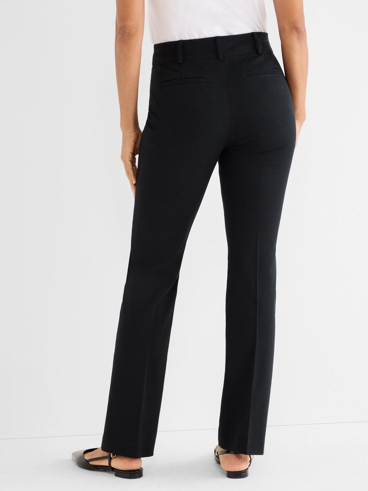 Model wears high-waisted black tailored pants with a straight fit and subtle back pockets.