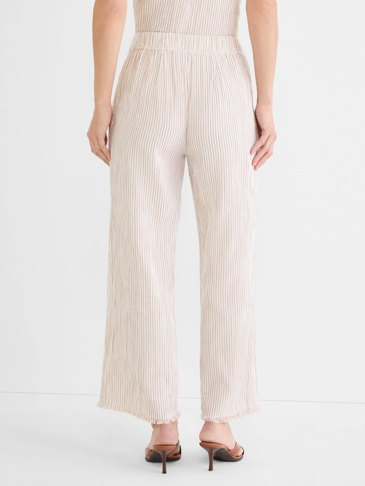 Cream wide-leg pants with vertical tan pinstripes, an elastic waist, and frayed hems.