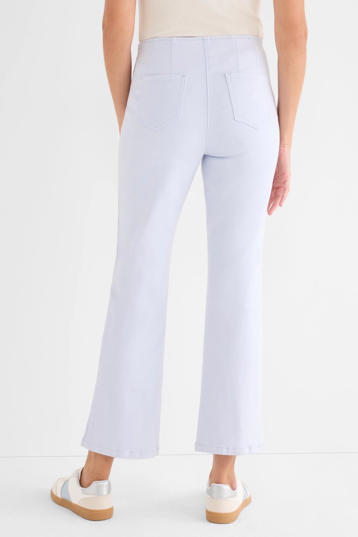 Pale blue high-waisted boot-cut jeans with back patch pockets and vertical leg seams.