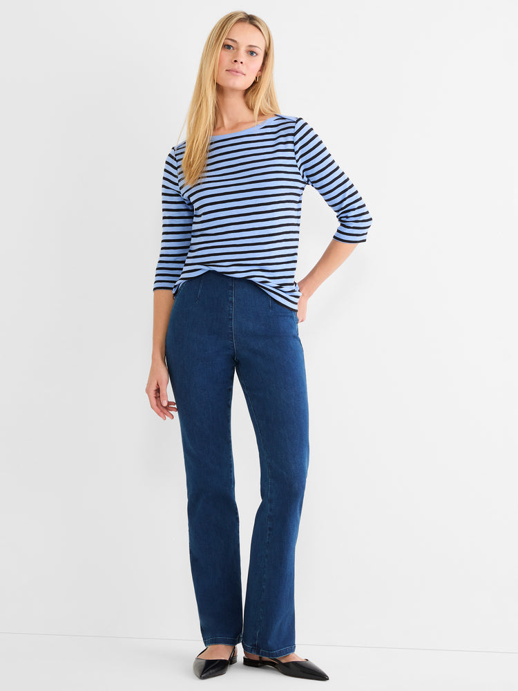 A fitted blue and black striped 3/4-sleeve top is paired with high-waisted, dark wash bootcut jeans.