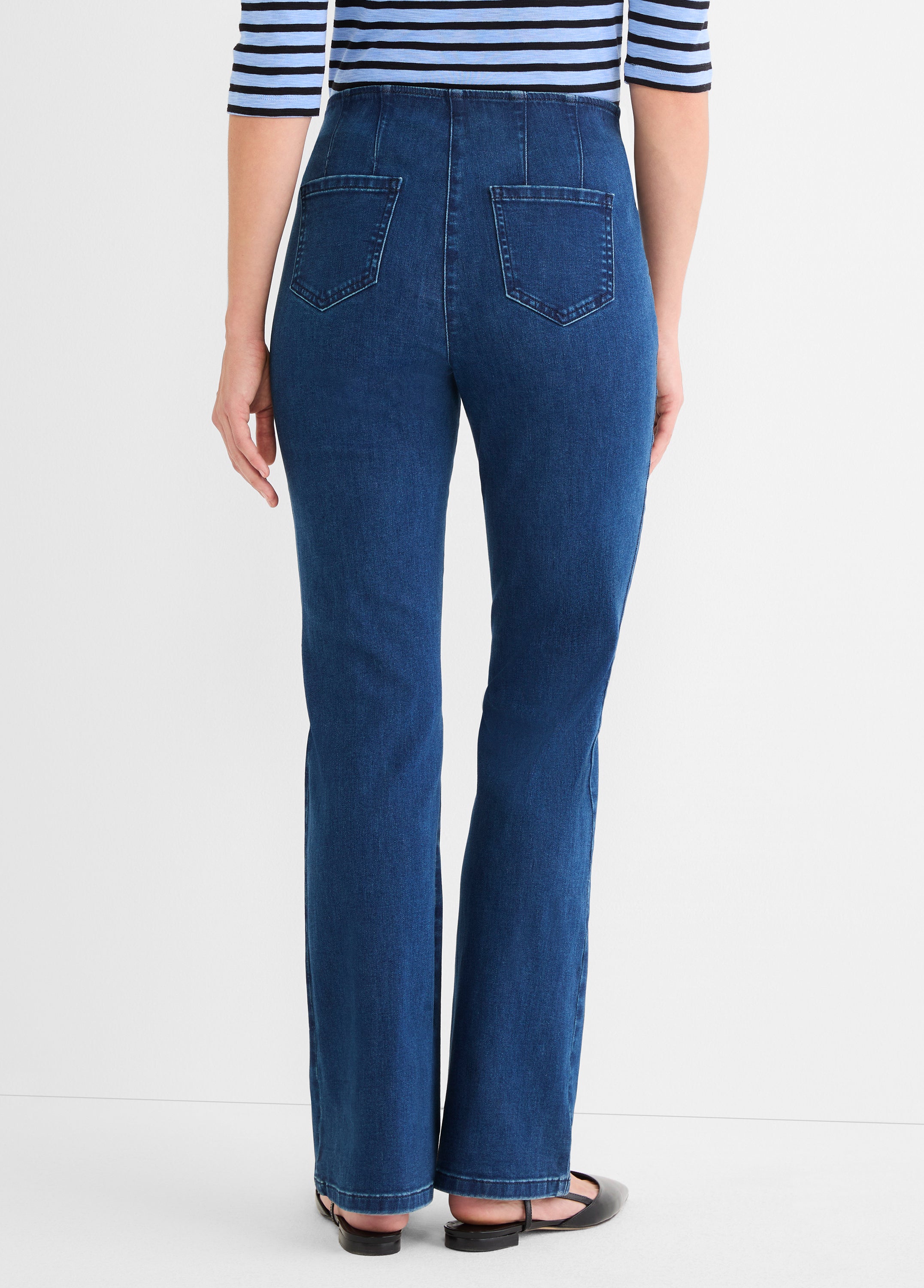 These high-waisted, dark wash blue jeans have a slim cut, back paneling, and square patch pockets.