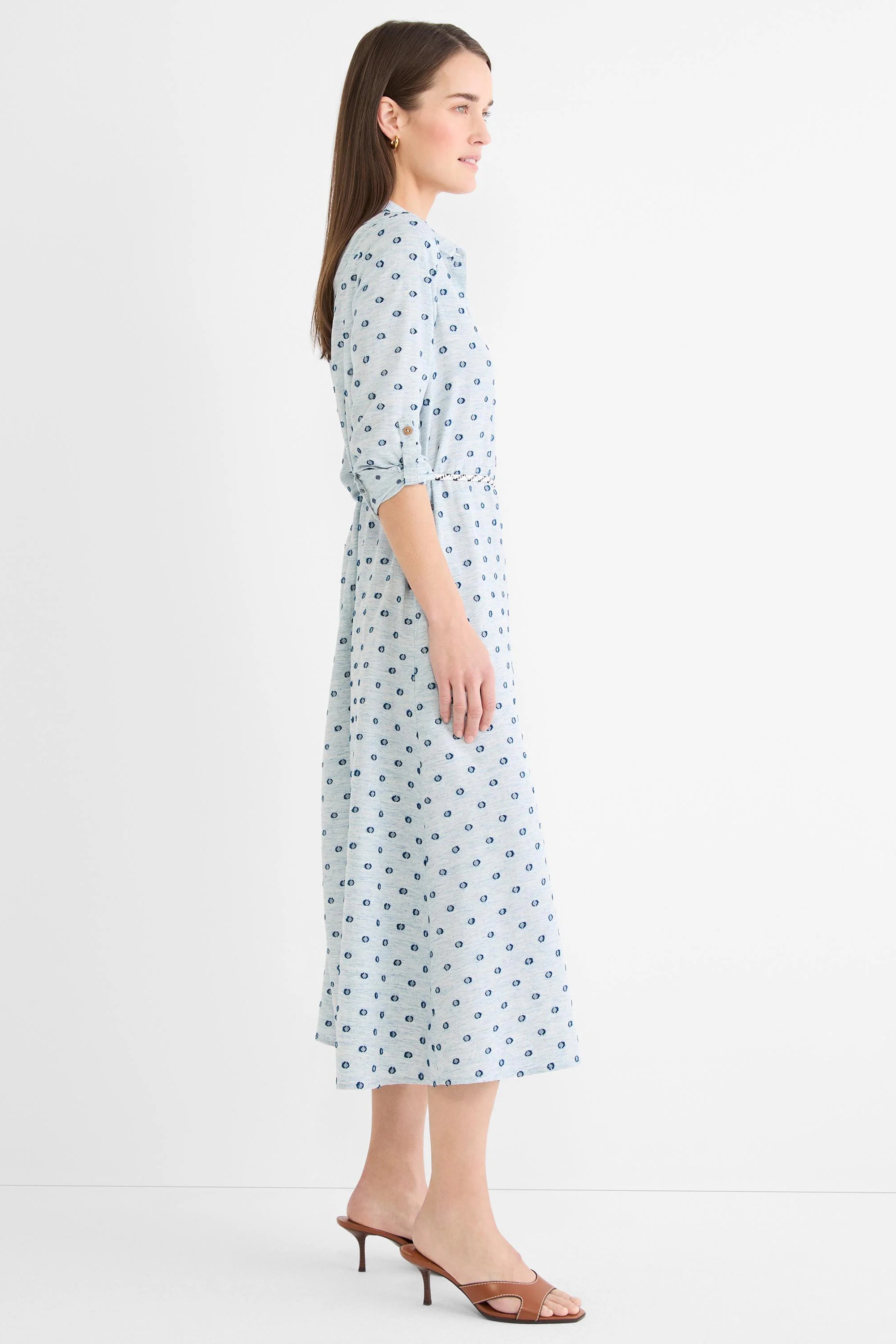 Light blue shirt dress with dark blue clipped dots, 3/4 rolled sleeves, self-tie belt, and midi length.
