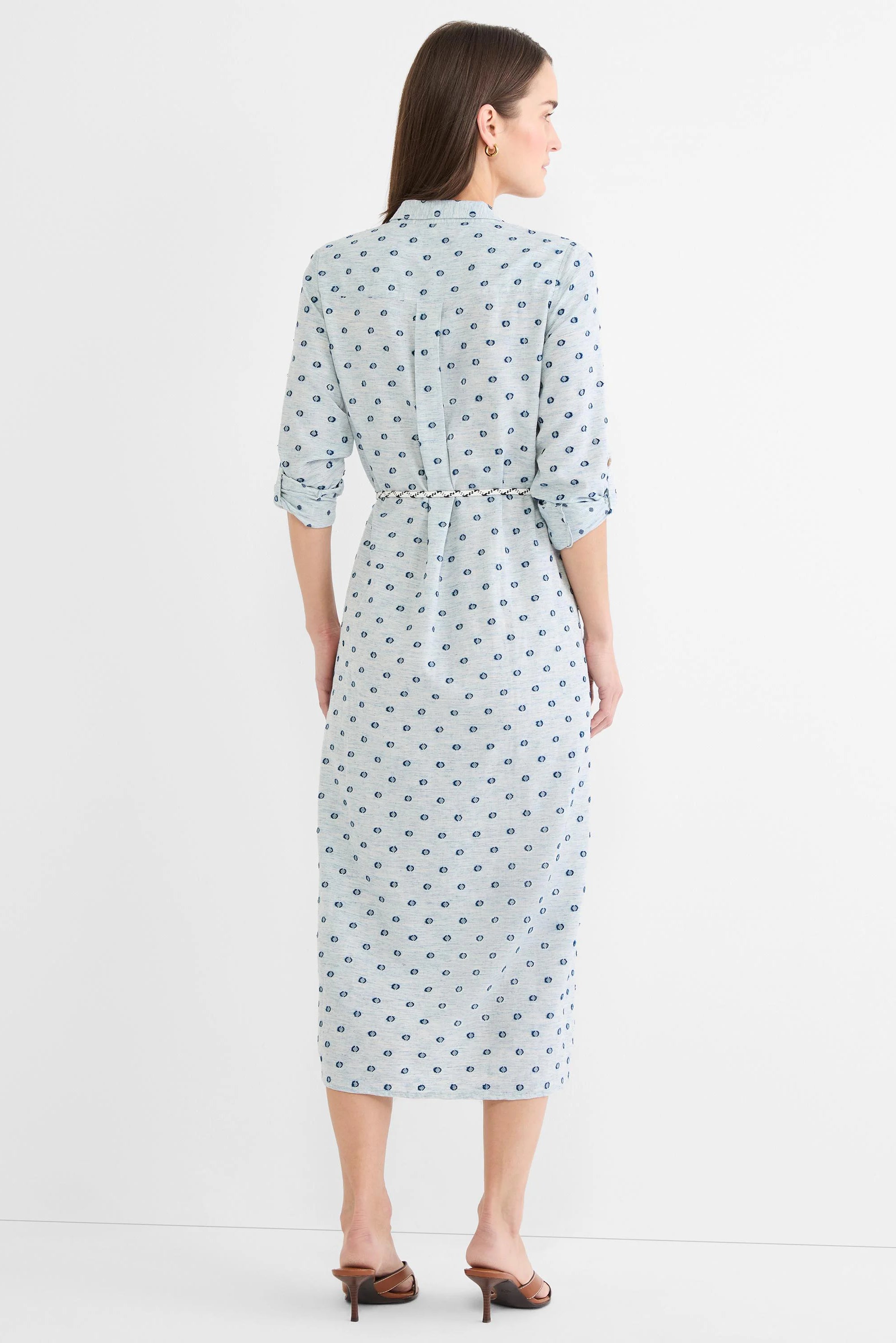 Light blue midi shirt dress with dark blue clipped dots, cuffed sleeves, and a white rope belt.