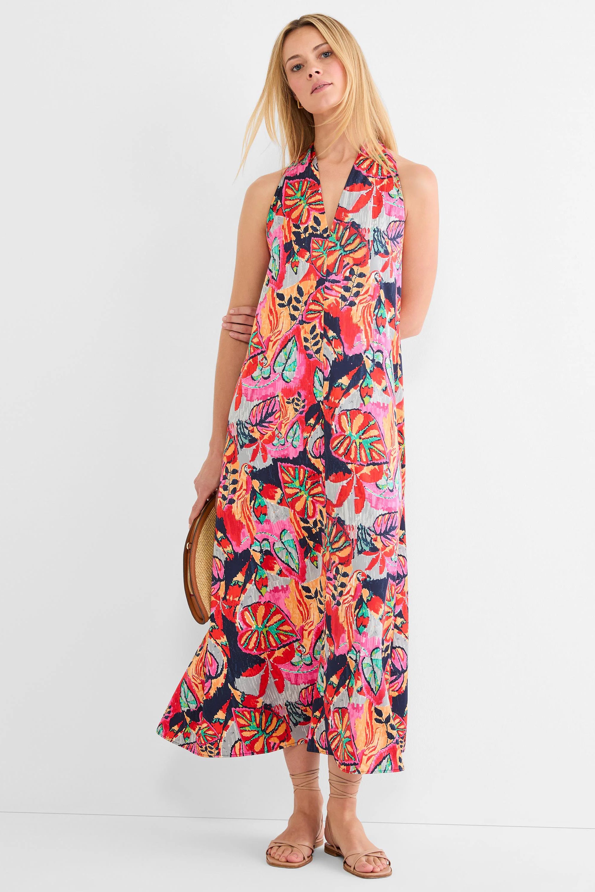 Halter neck maxi dress with a vibrant, abstract print in navy, red, pink, orange, teal, and gray colors.