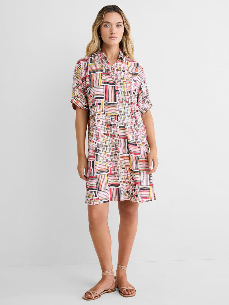 This relaxed shirt dress features a multicolored geometric print with short cuffed sleeves and a button down collar.