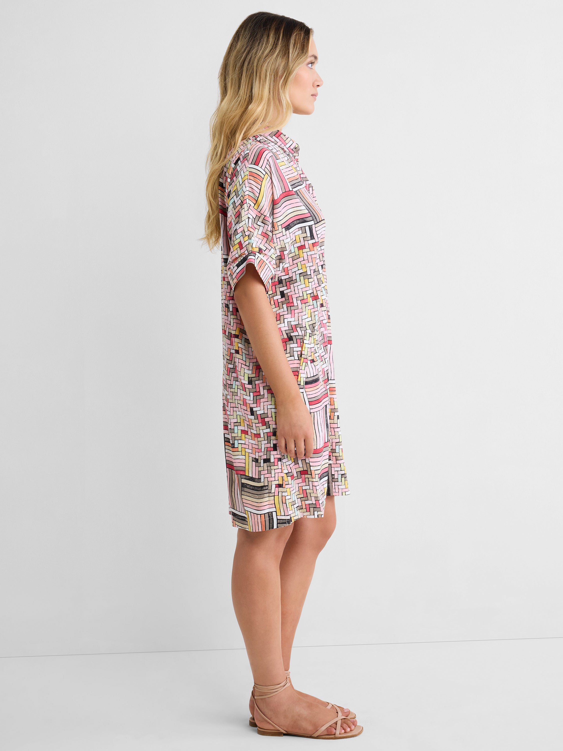 A relaxed pink geometric shirt dress features short cuffed sleeves and a classic collar in a breezy knee length fit.