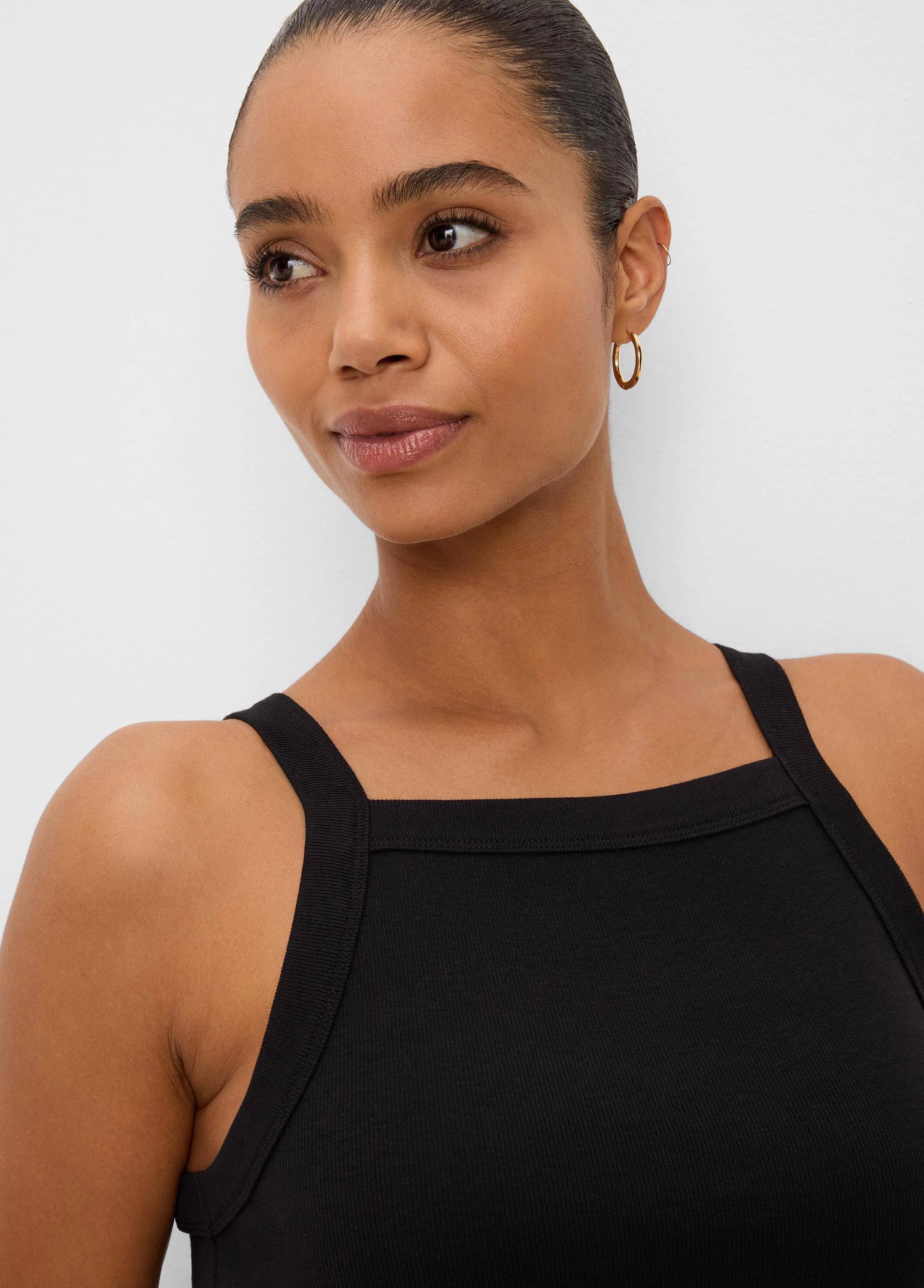 Black ribbed square neck tank with wide straps, worn by a model.