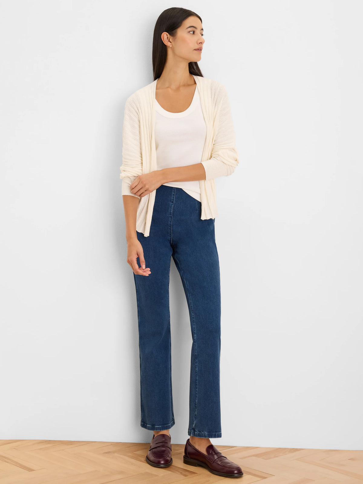 Cream accordion-textured open-front cardigan with long sleeves, shown on a model.