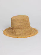 Beige raffia bucket hat with a frayed brim and a simple tie.