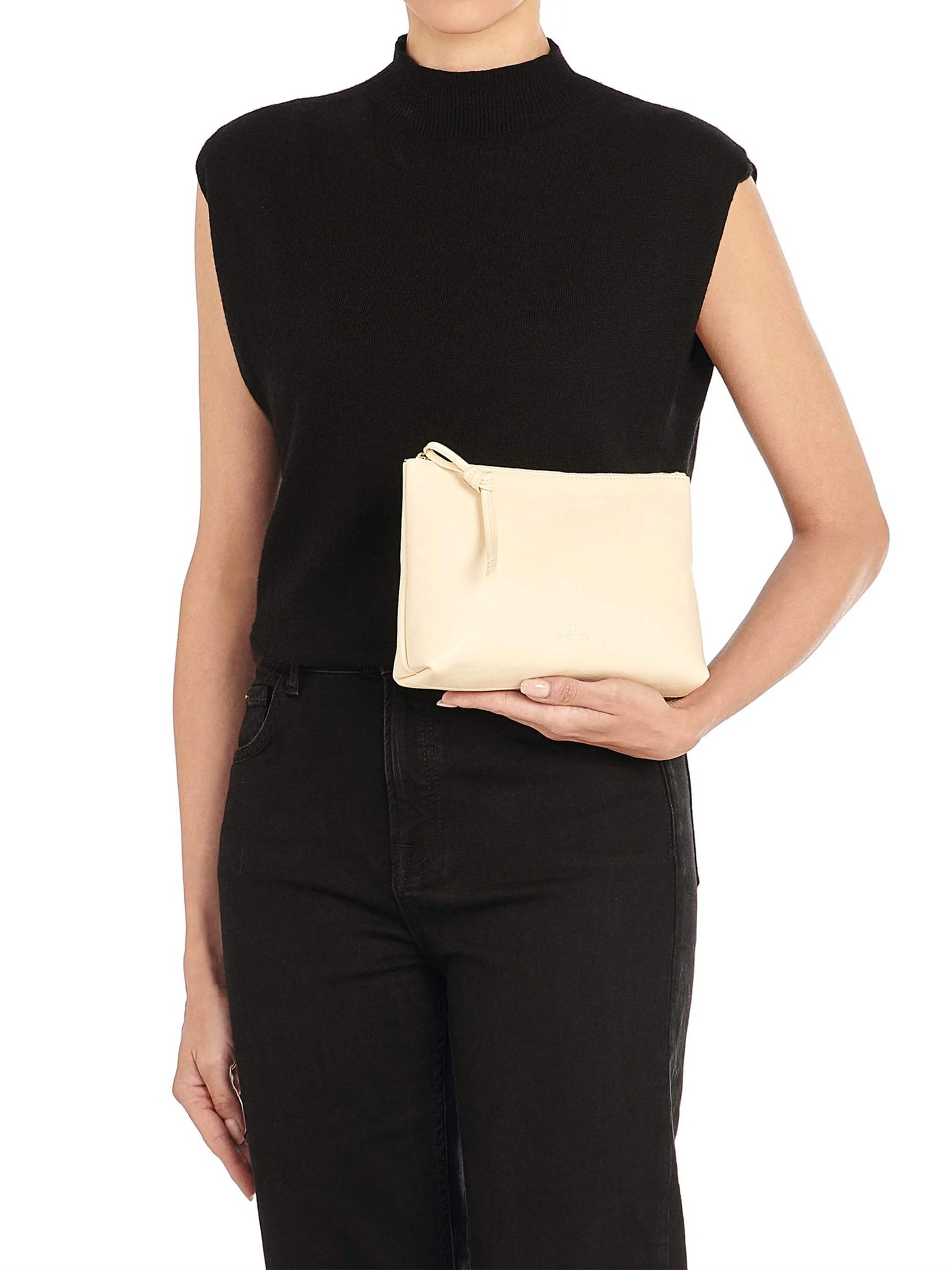Small, cream-colored leather zipper case with a top zipper and a knotted pull, held in a model's hand.