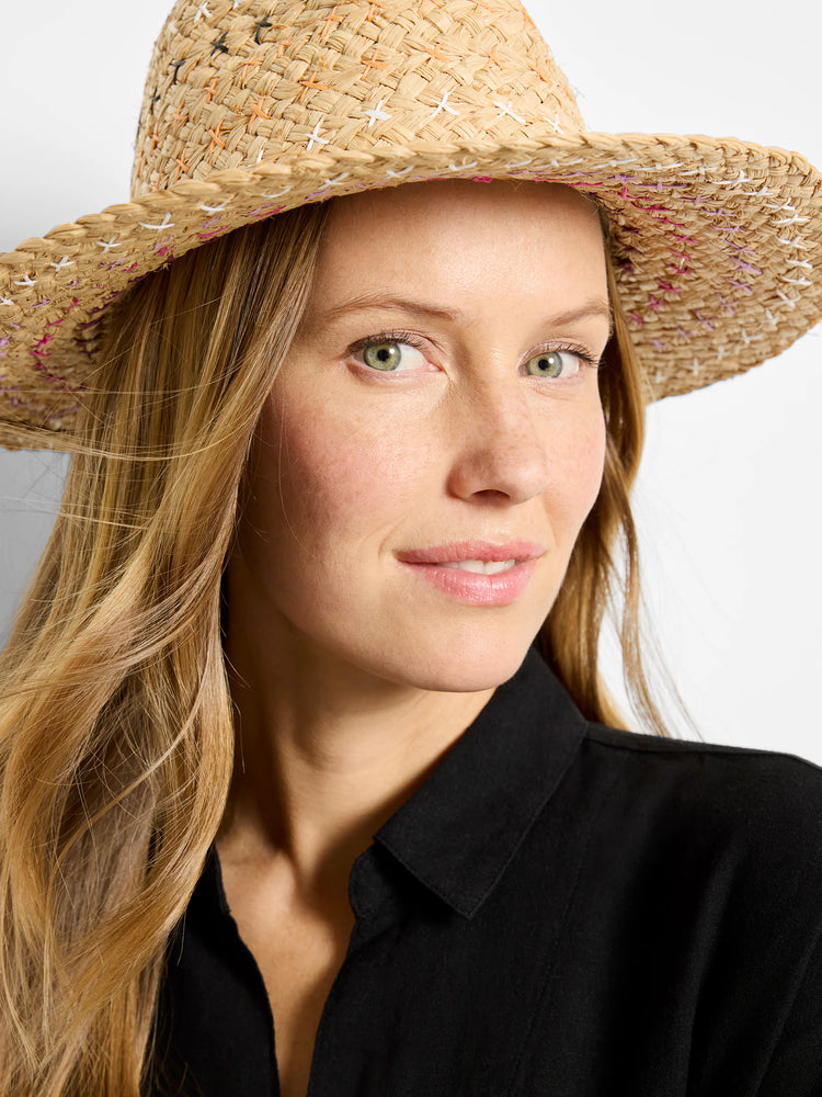 Light tan woven straw hat with visible multicolored 'X' stitches in white, orange, purple, and pink.