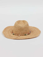 Wide-brimmed tan straw hat with an indented crown. A natural cord with colorful red, green, gold, blue, pink beads...