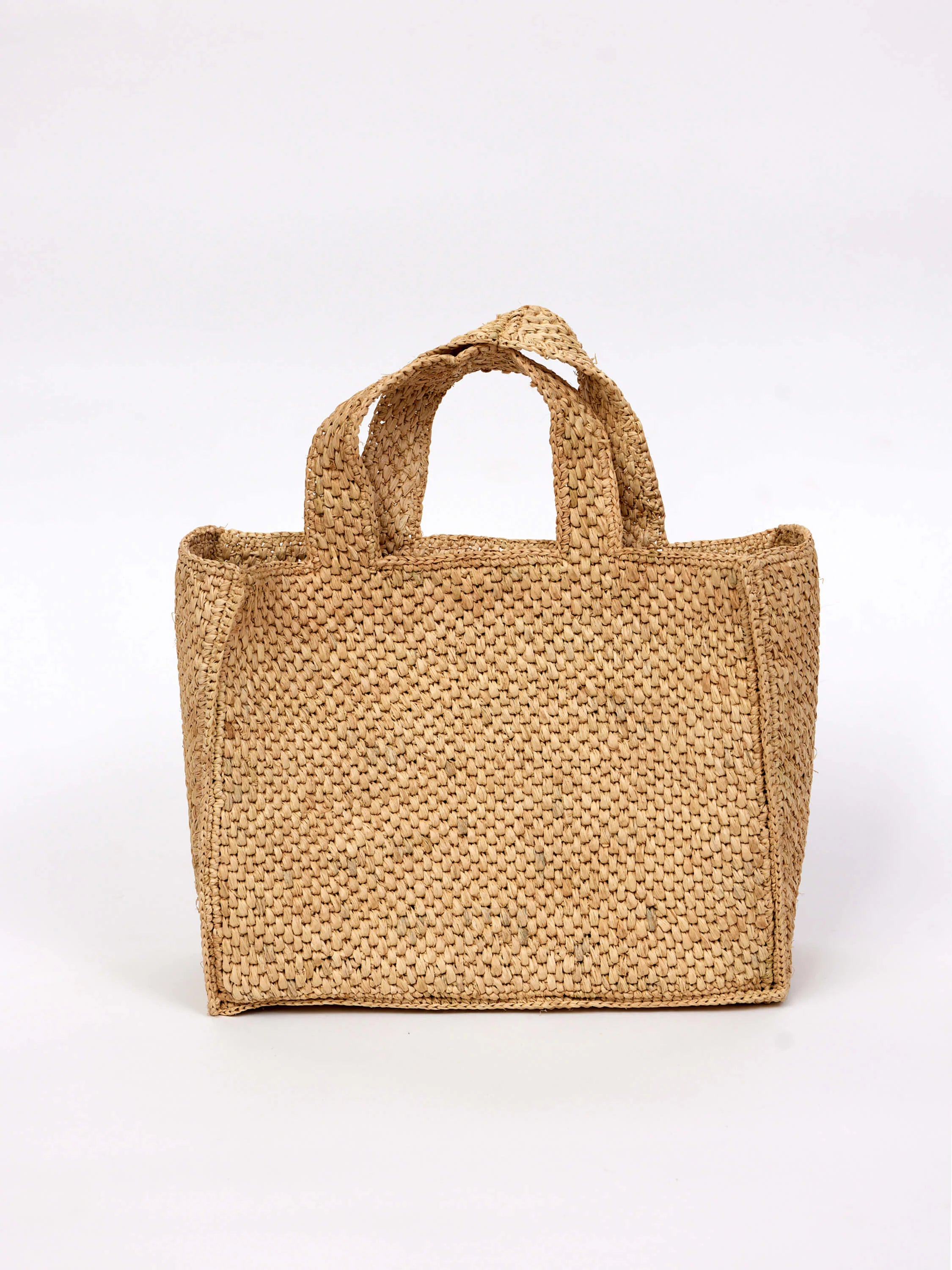 Light beige, woven straw tote bag with double top handles. Rectangular shape.