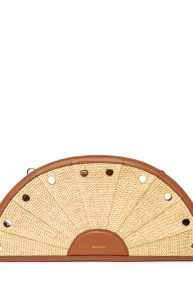 Fan-shaped light tan woven straw clutch with brown leather trim and alternating gold and silver studs.