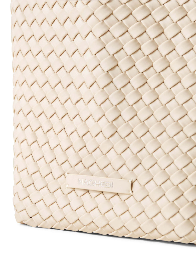 Off-white woven tote bag. Close-up shows a tightly woven, textured pattern. Brand label visible.