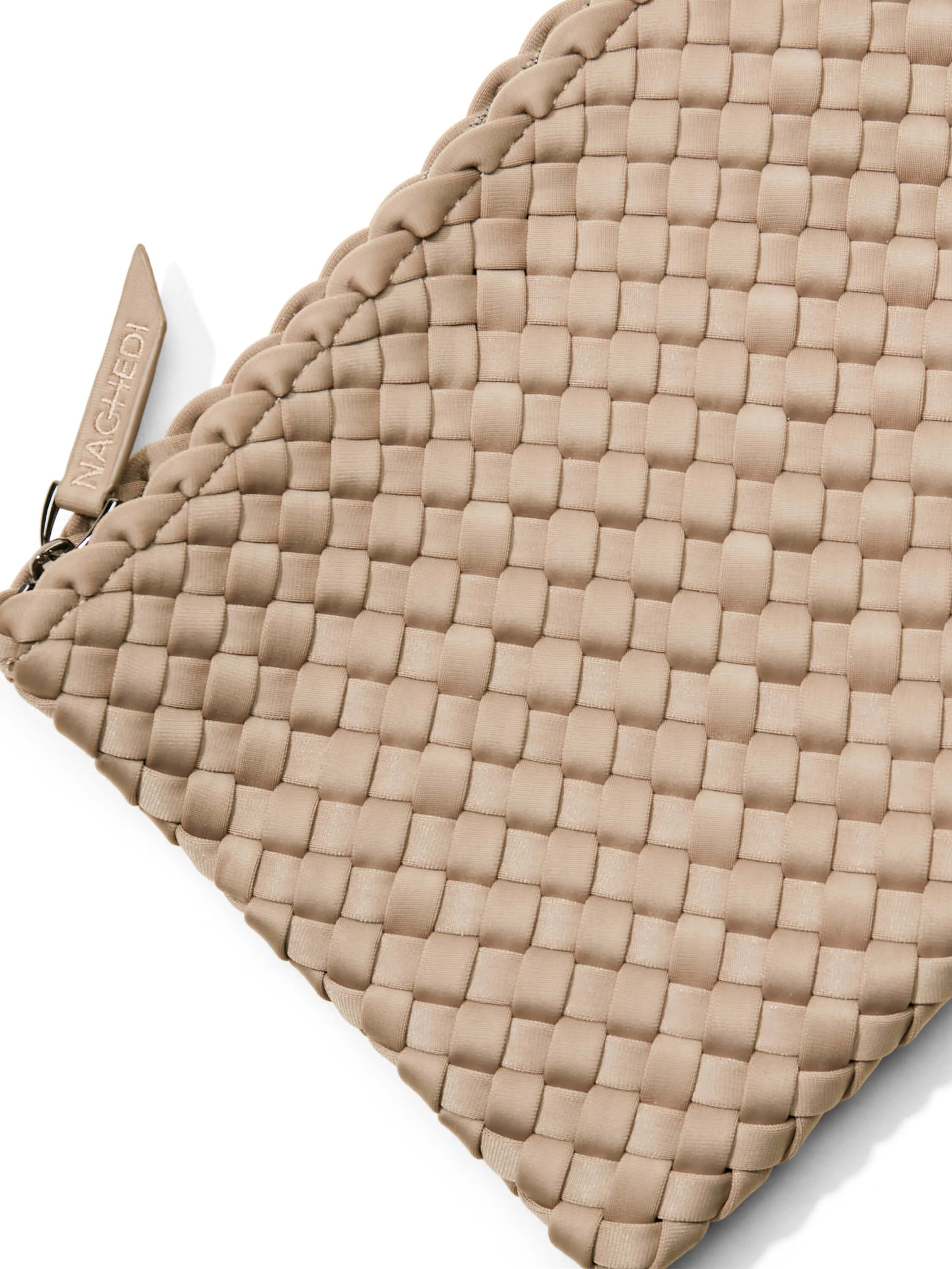 Light tan bag with a textured woven pattern of interlocking flat strips. A small "NAGHEDI" brand tag is visible.