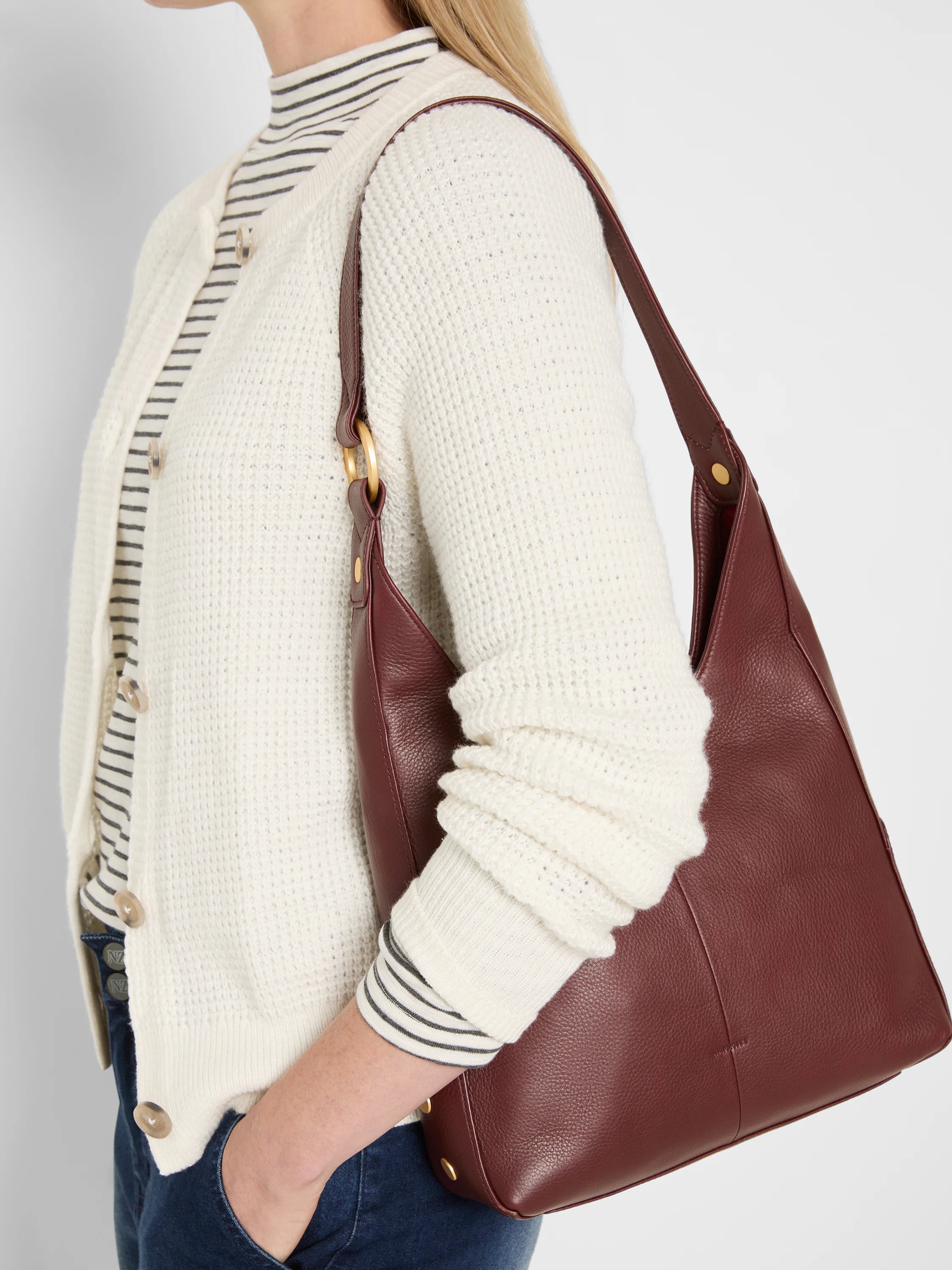 Medium burgundy pebbled leather bag with a slouchy shape, single strap, and gold-tone hardware.