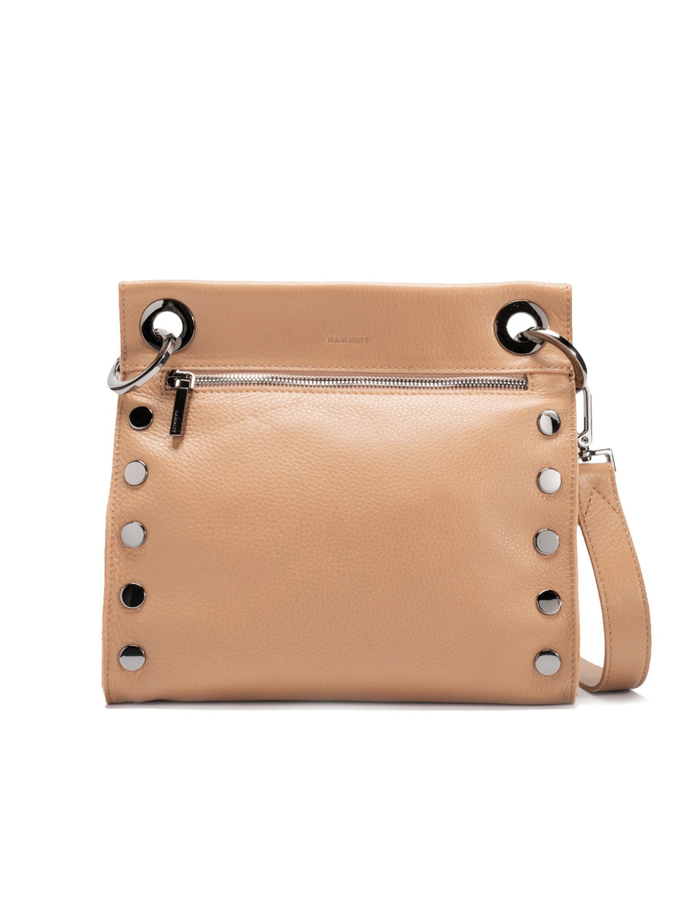 Tan pebbled leather crossbody bag with silver hardware, including a front zipper and studs along the sides.