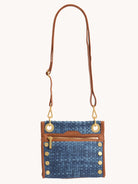 Small blue woven clutch with tan leather trim, gold hardware, top zipper, and decorative studs.