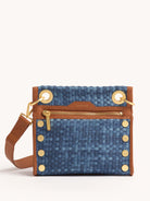 Small blue denim clutch with tan leather trim, gold zipper, and studs.  Features a woven texture.