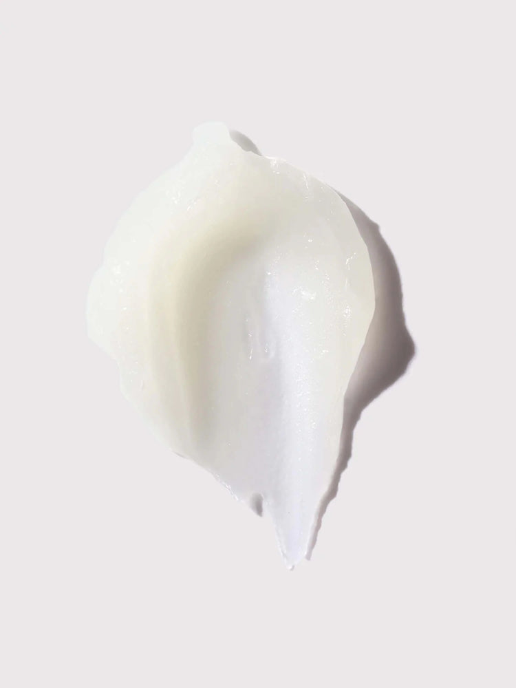 Off-white balm swatch; slightly translucent, irregular shape.