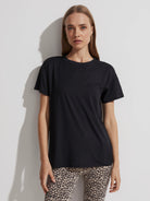 Black crew neck t-shirt with short sleeves and a relaxed fit.